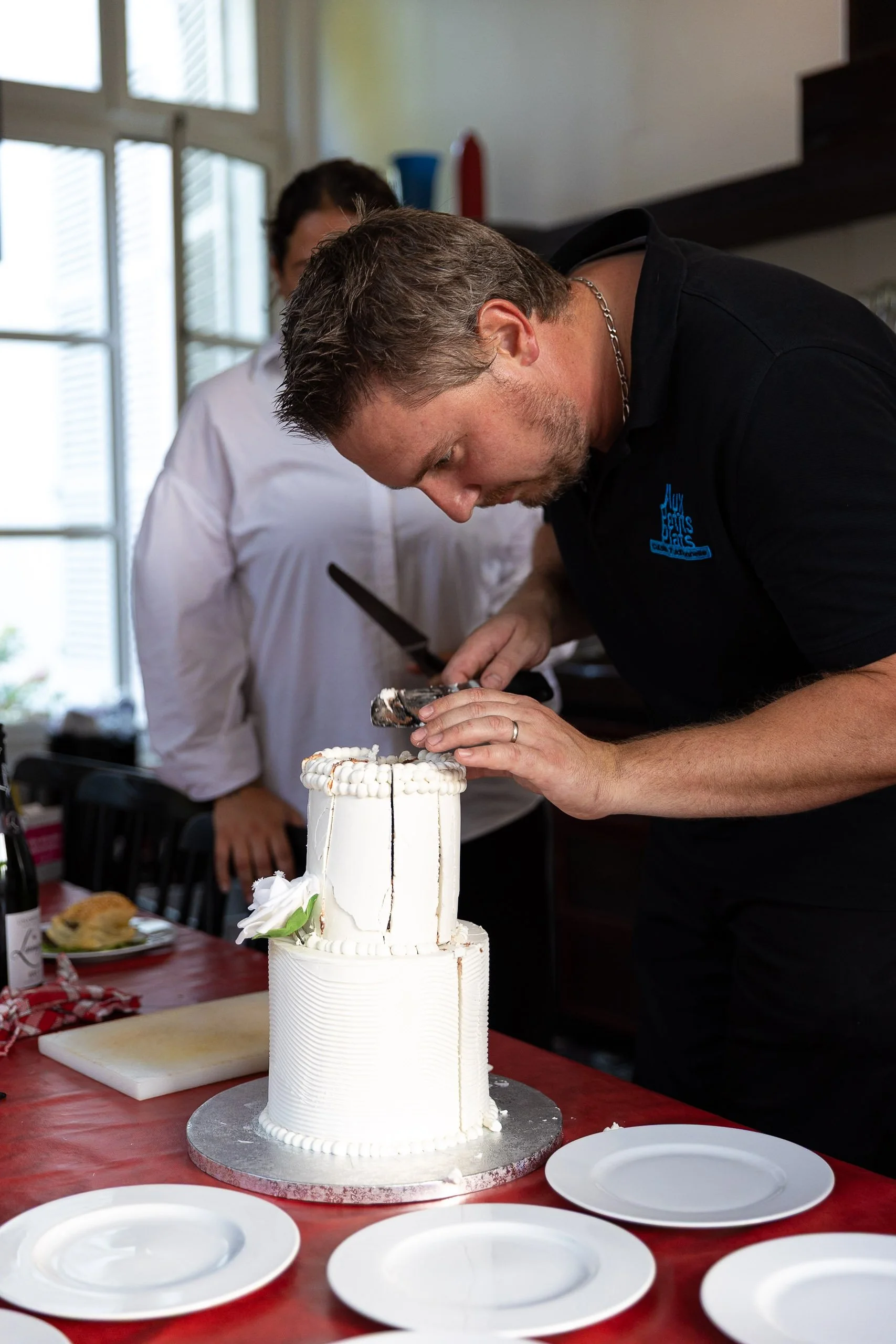 Chef cutting cake at destination wedding dinner