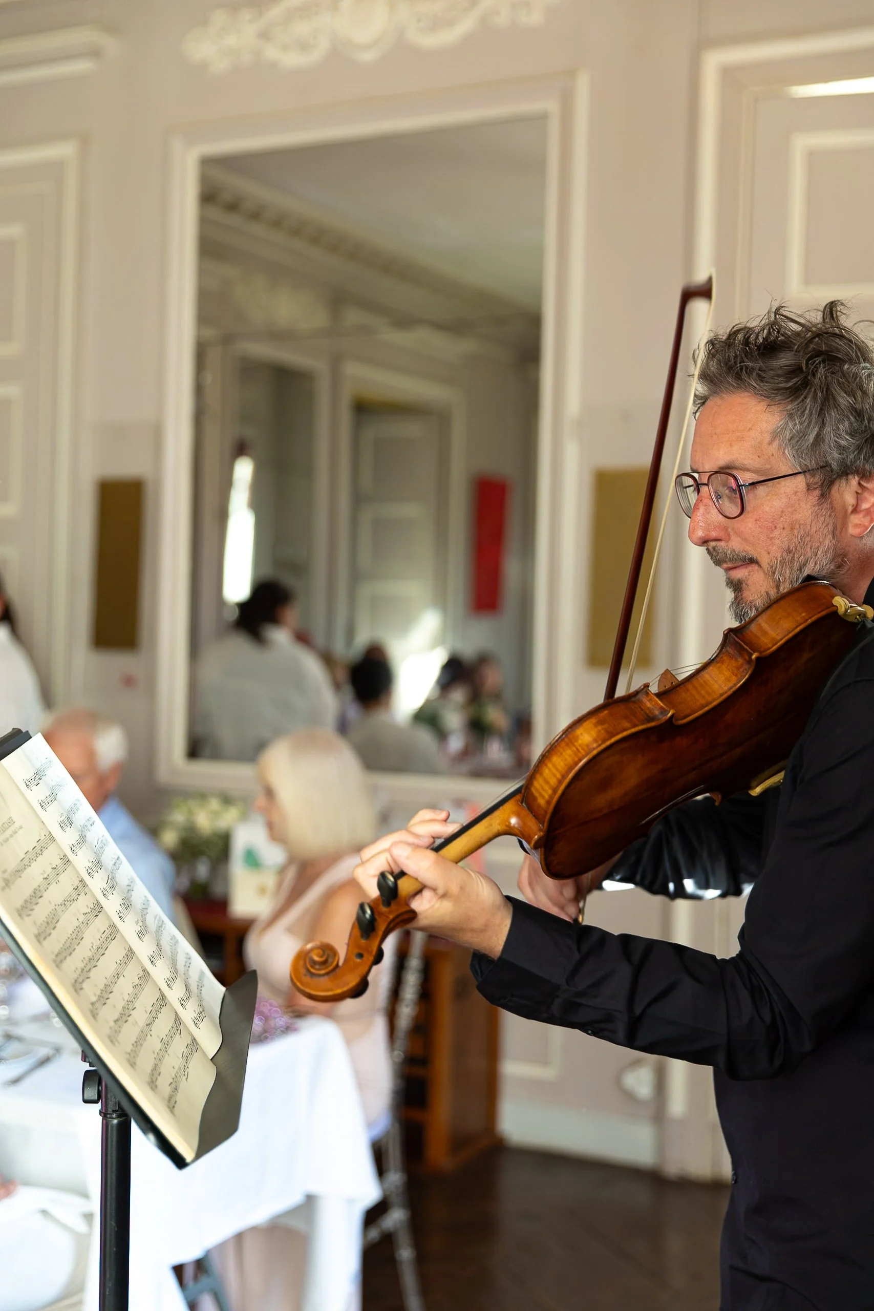 Violinist playing wedding at French chateau castle wedding dinner 