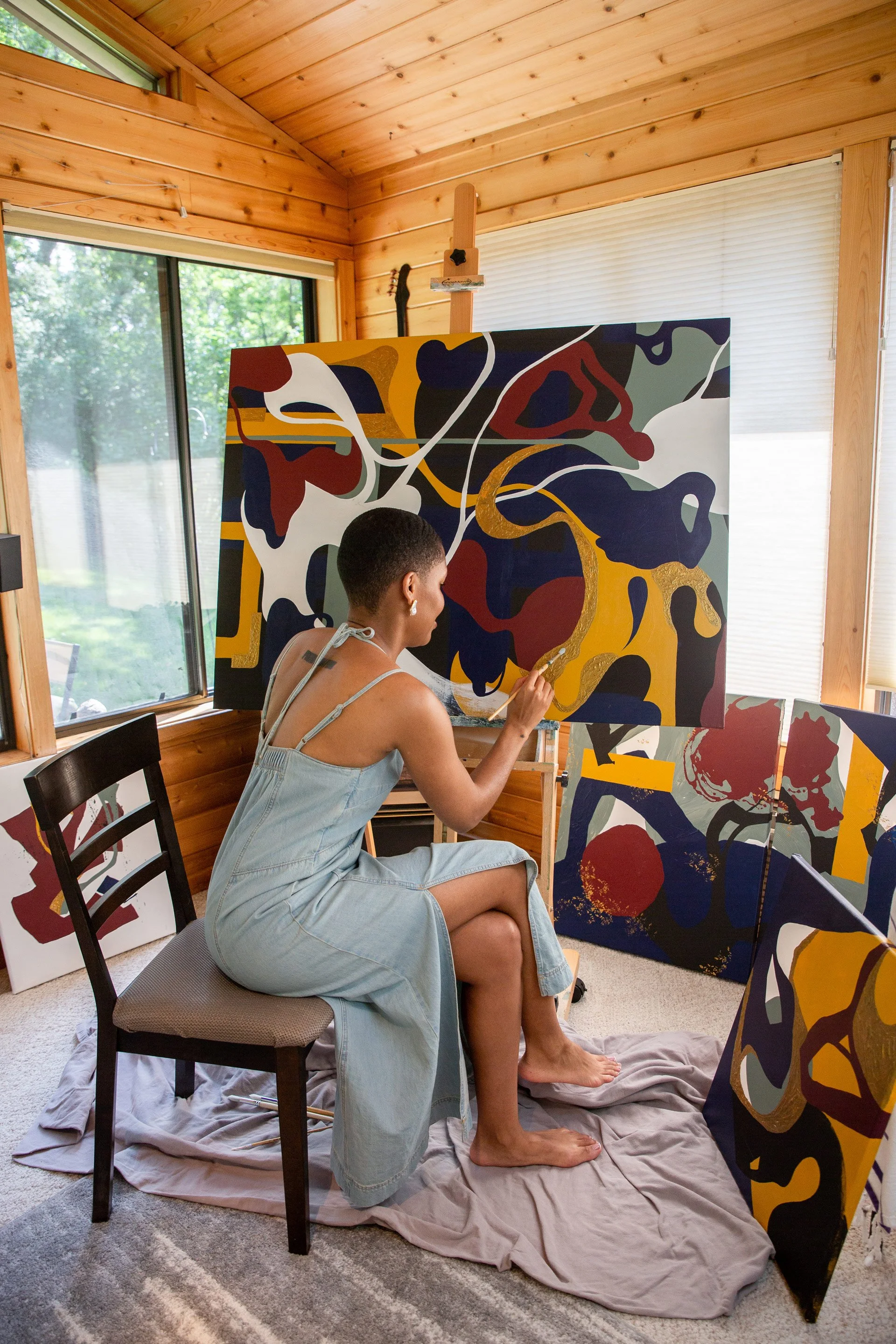 Minnesota abstract artist Nailah Ali photographed creating alongside original paintings from the Moments in Grief collection.