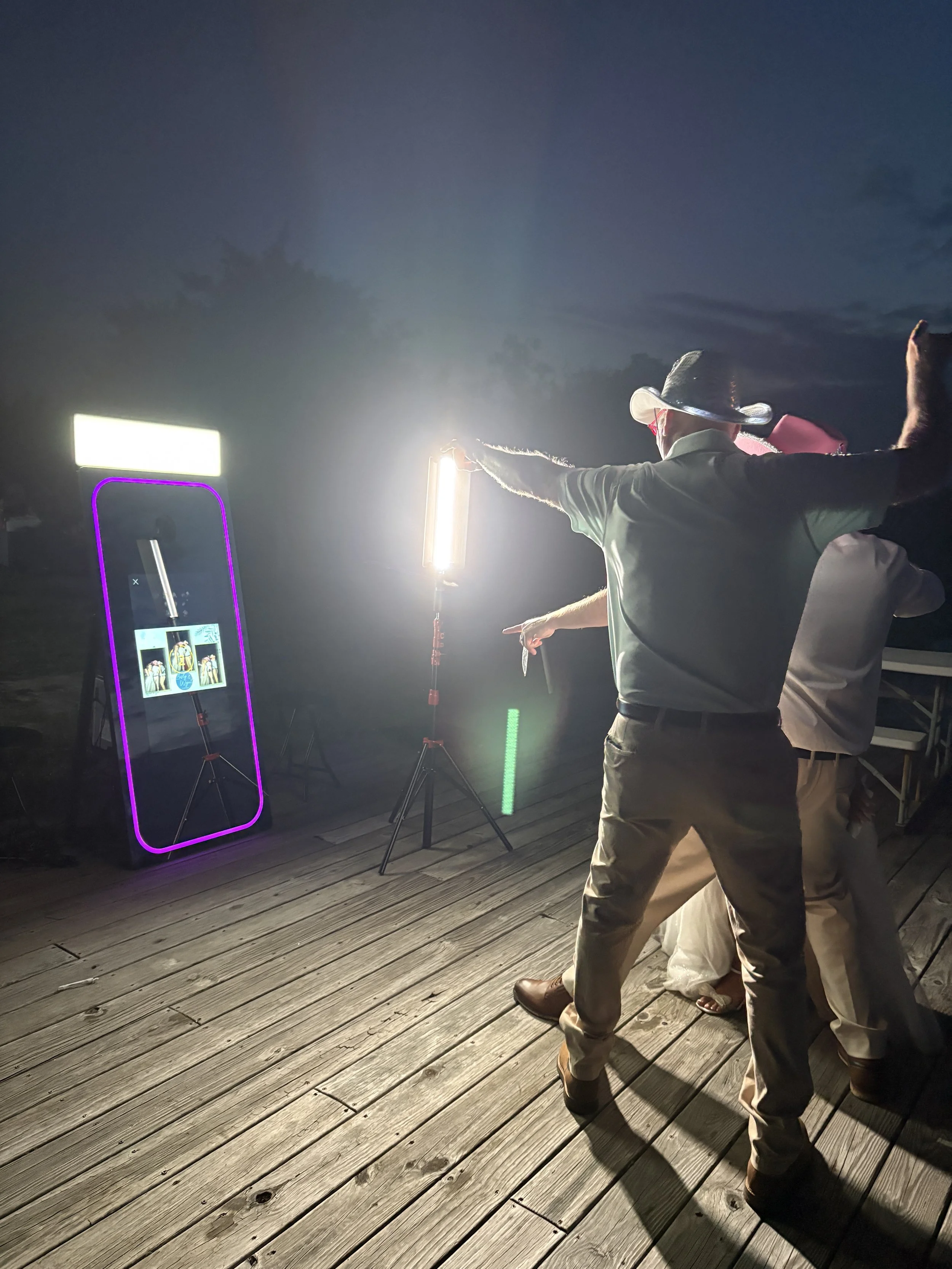 People having fun with the mirror photobooth for a wedding in Burgaw NC at Penderlea Farms.