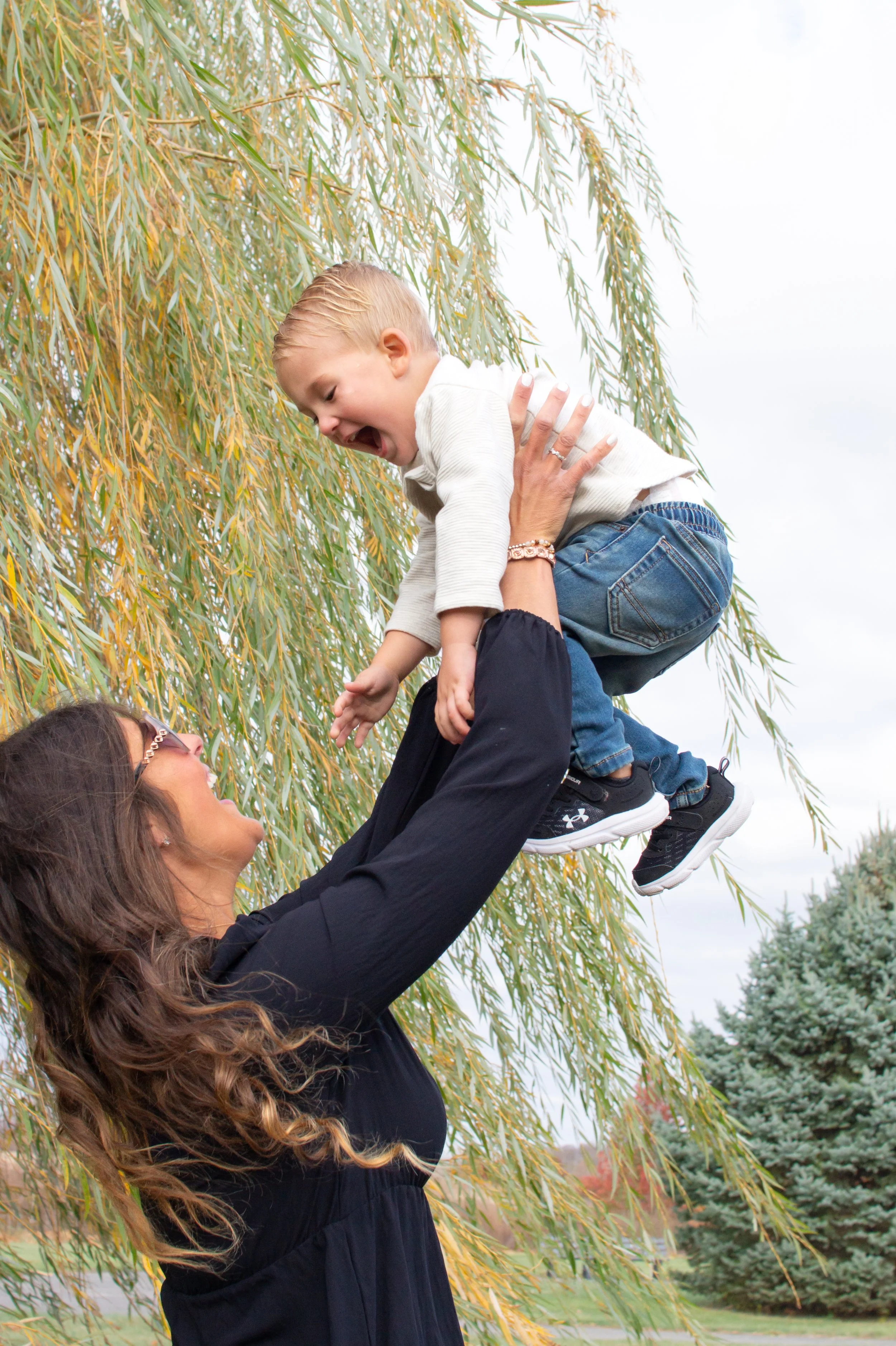 Mom and son laughing in a photograph in Huntington Indiana with a willow tree behind them
