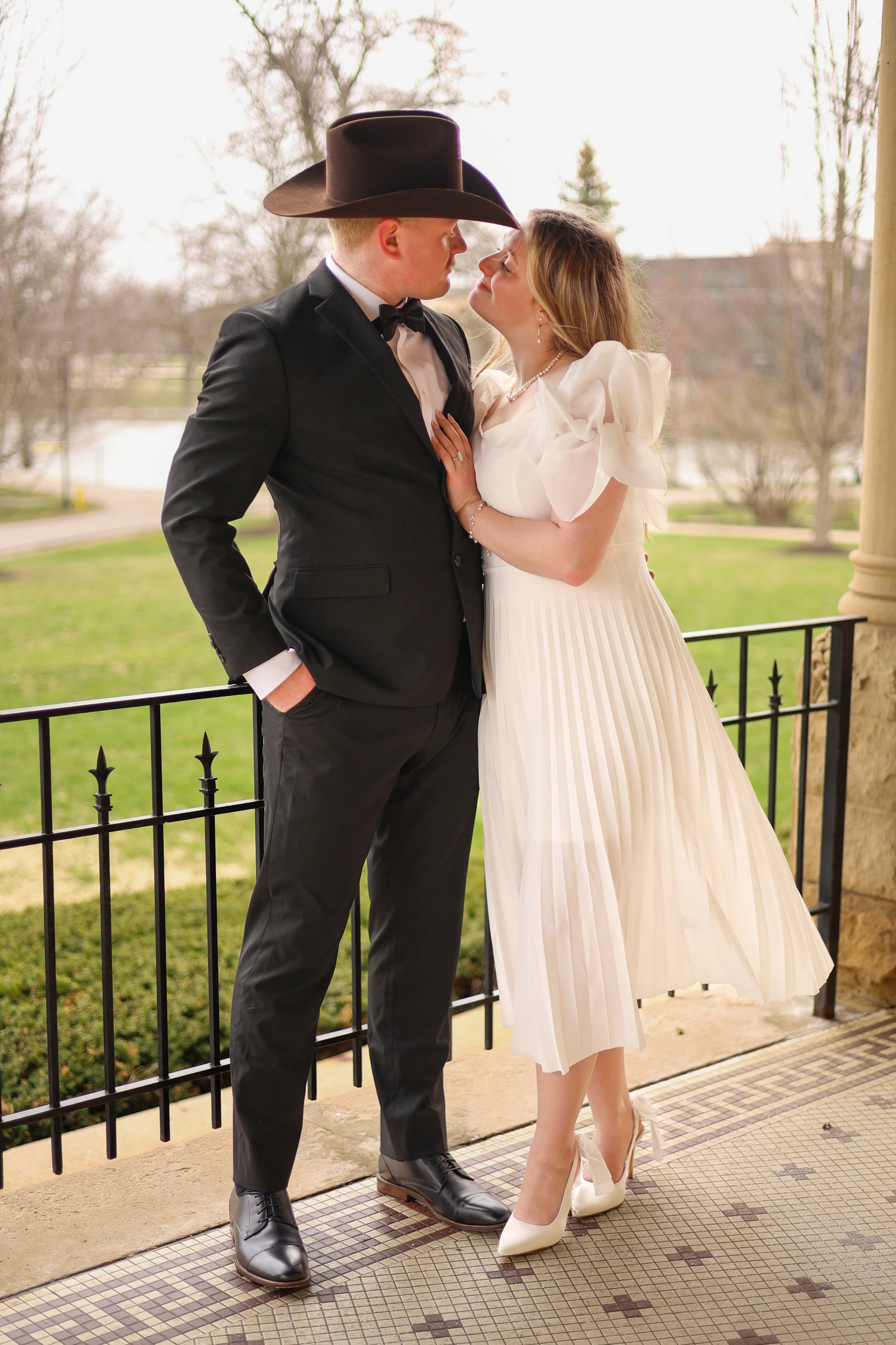 Couple celebrating engagement looking at each other at St. Francis in Fort Wayne