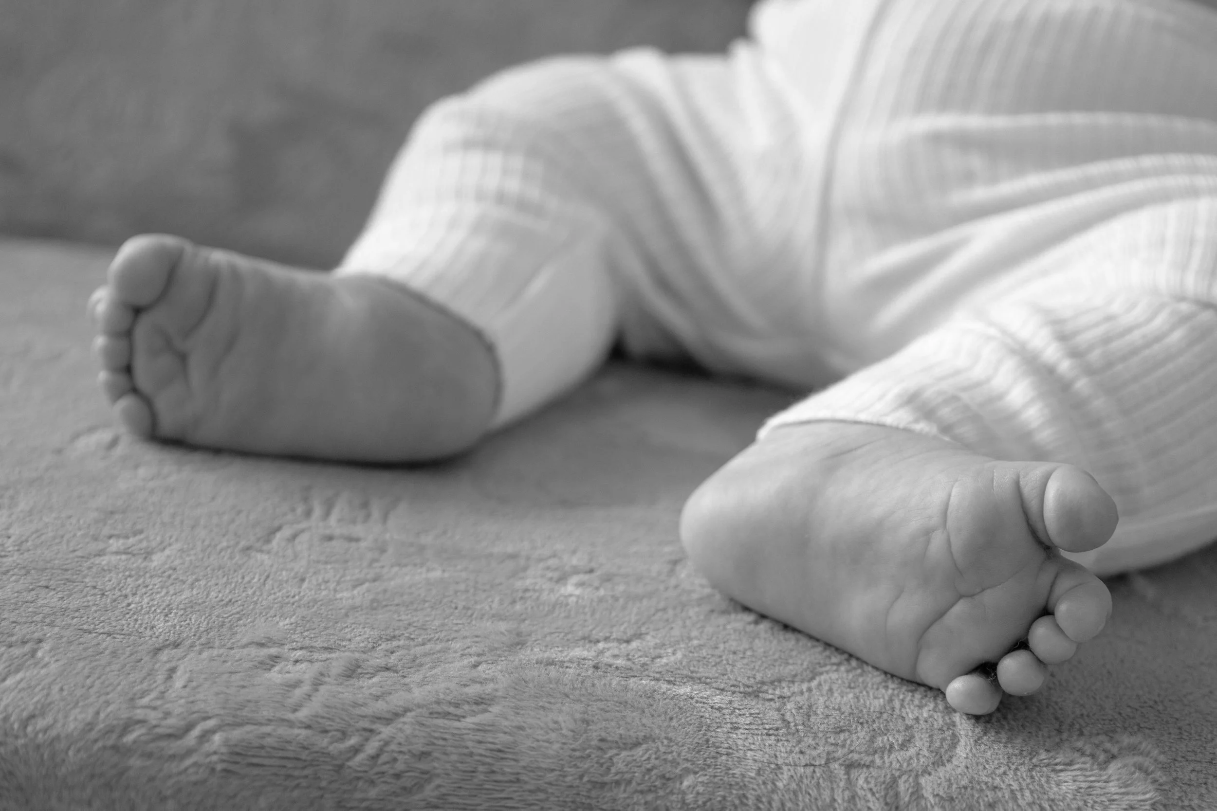 Baby feet and baby toes captured in photograph in Huntington Indiana using black and white imagery