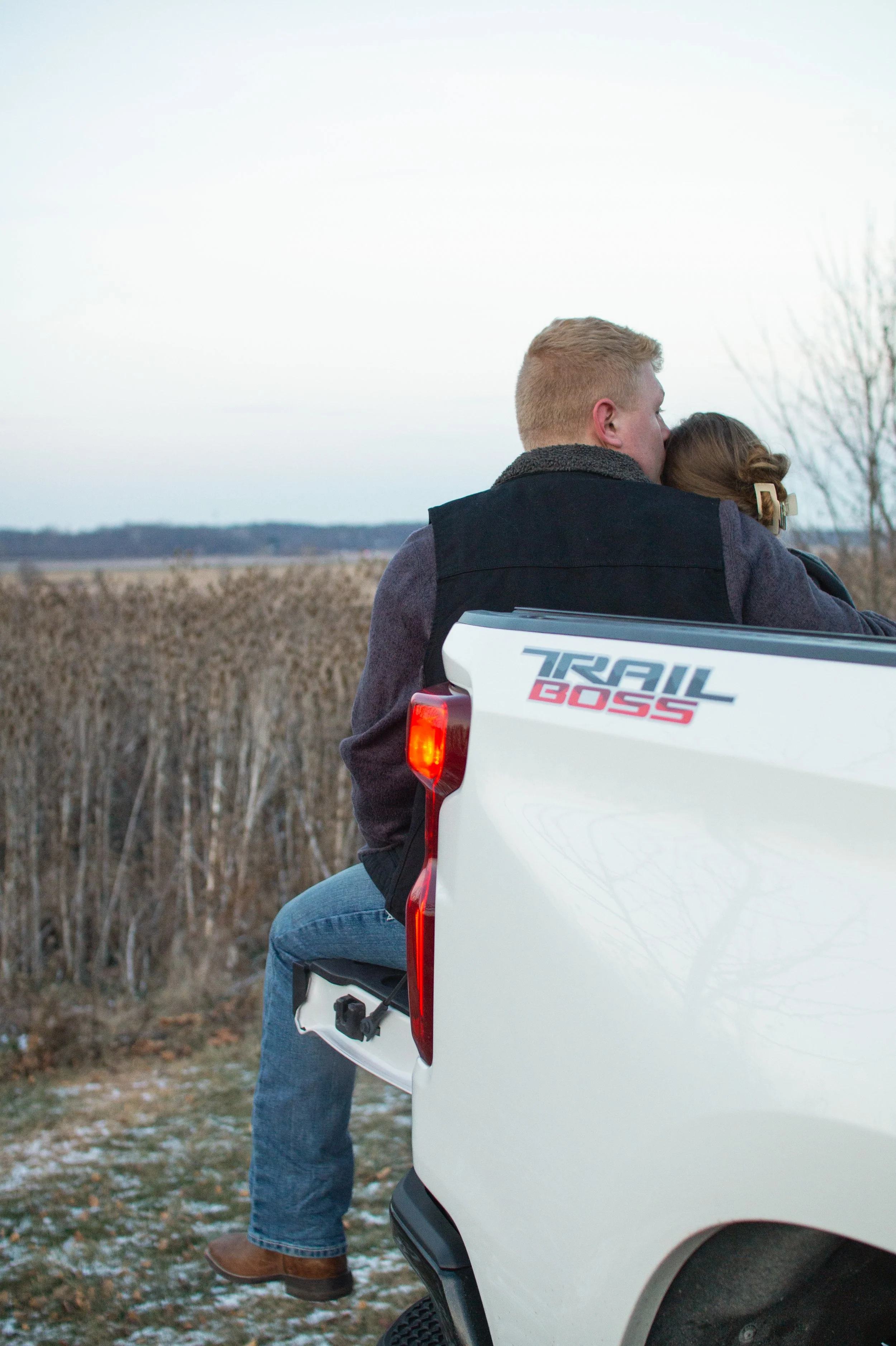 man and woman sitting in a pick up truck and candidly being together in fort wayne