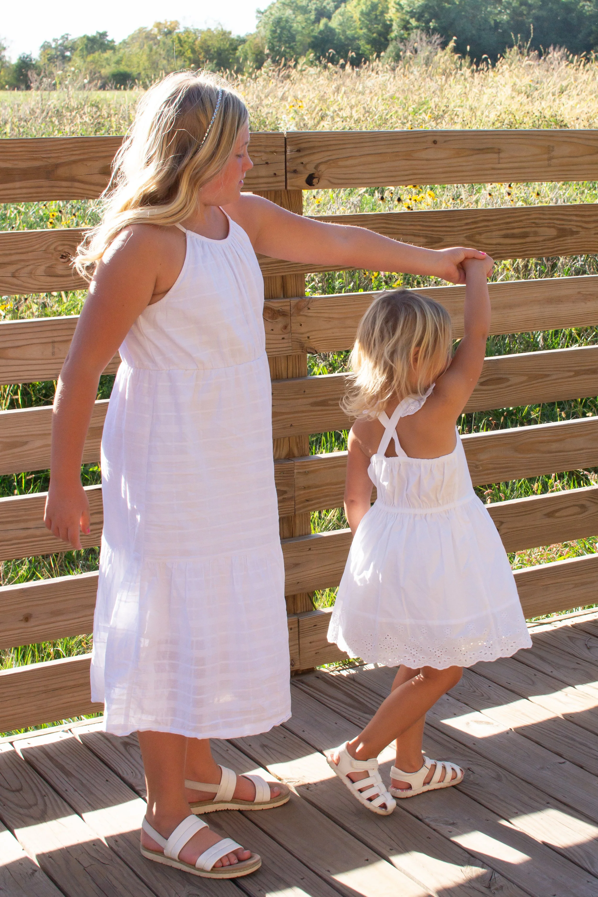 Sisters twirling in a park in Huntington indiana