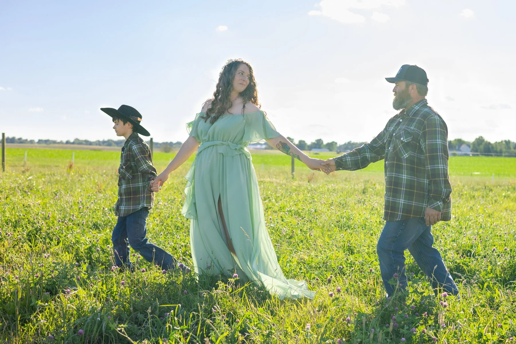 Family walking through tall grasses in a farm field countryside setting photographed in North Manchester, Indiana