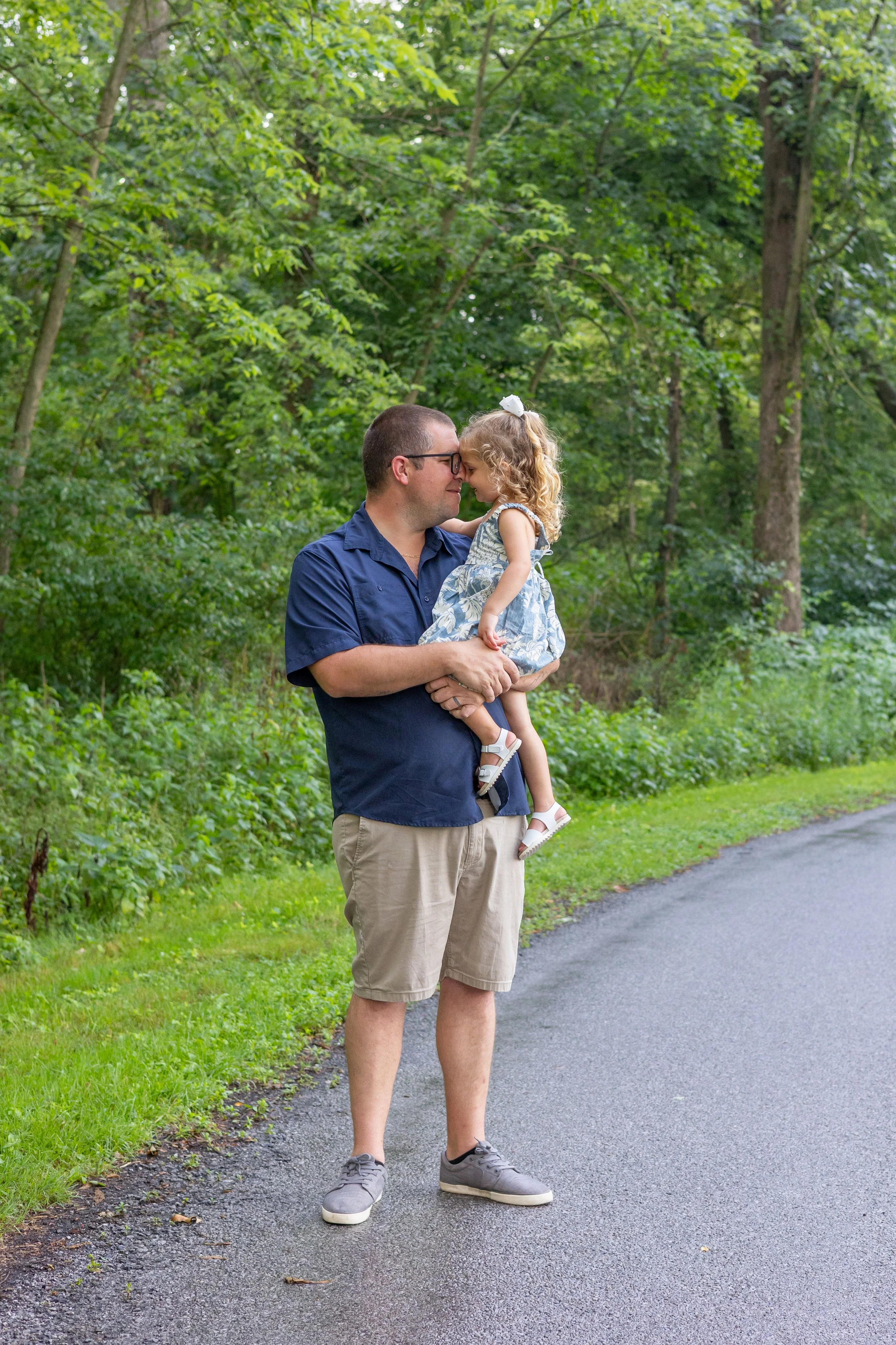 Dad and daughter hugging in Huntington Indiana photographed just after a rain