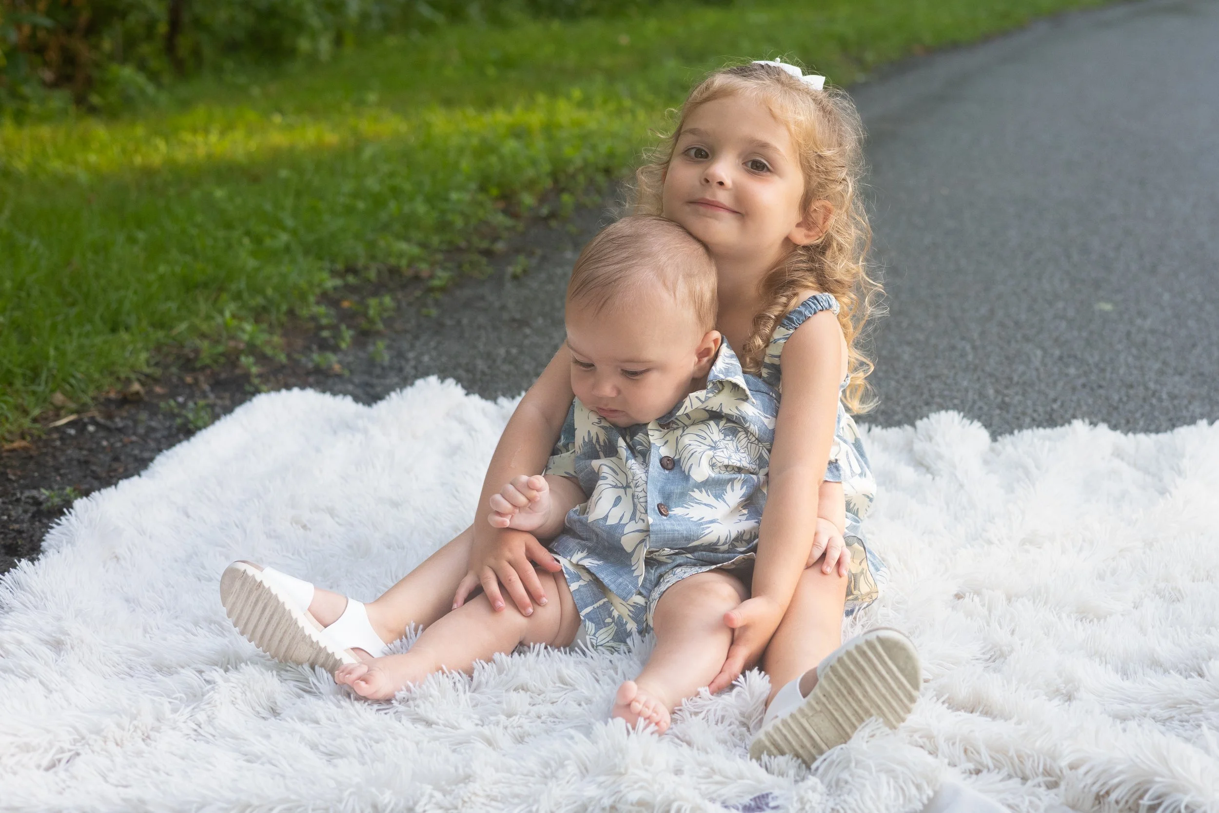 Sister and brother on a blanket in a park in Huntington indiana