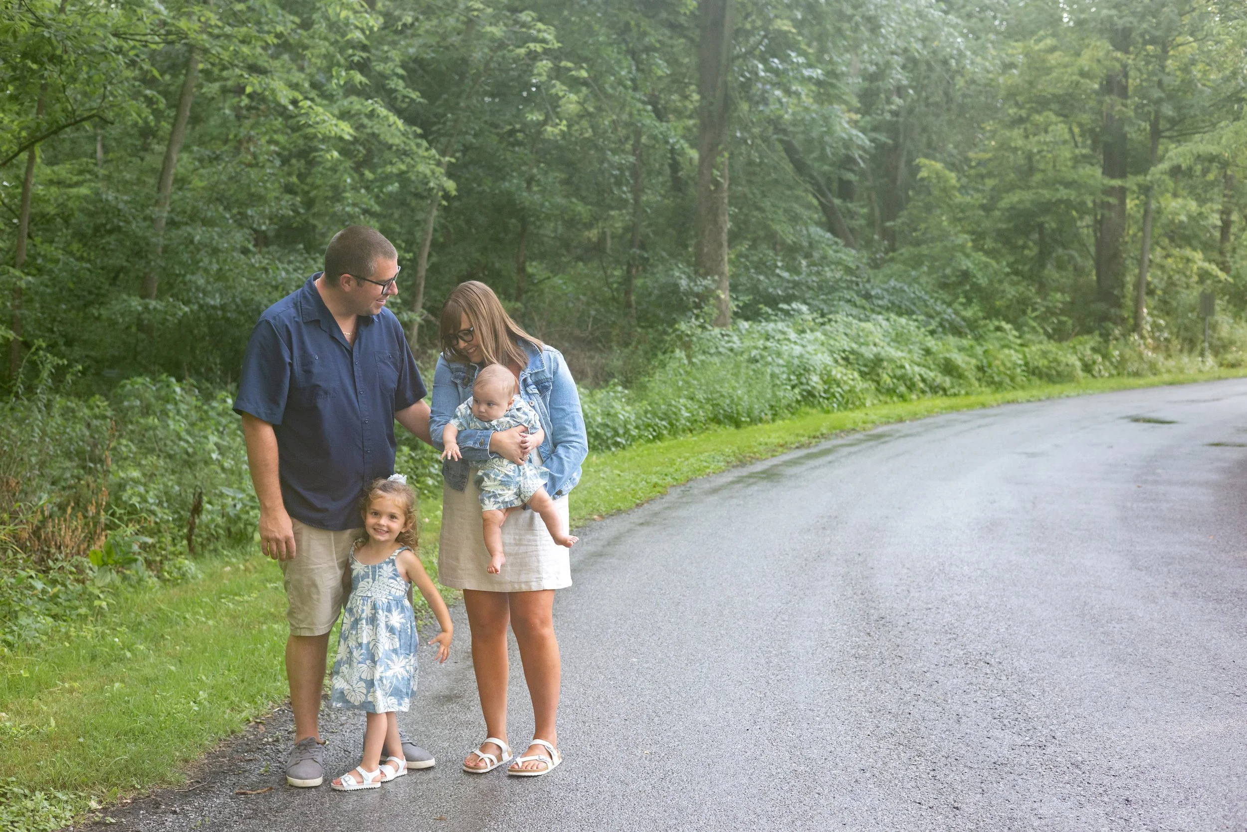 Family photographed together just after a rainfall at park in Huntington Indiana with a newborn and toddler