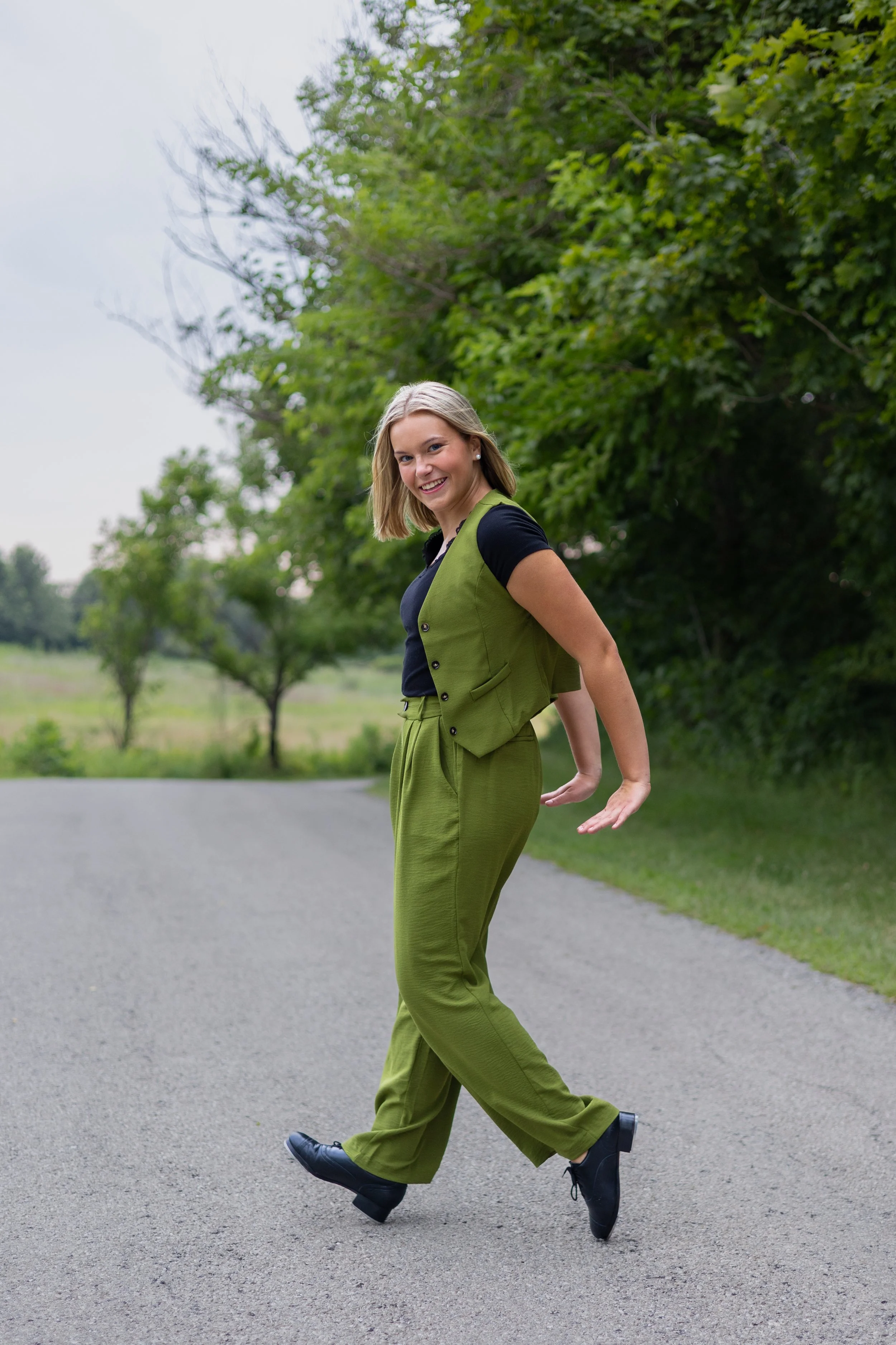 High school senior dancer at a park doing candid movements in natural images