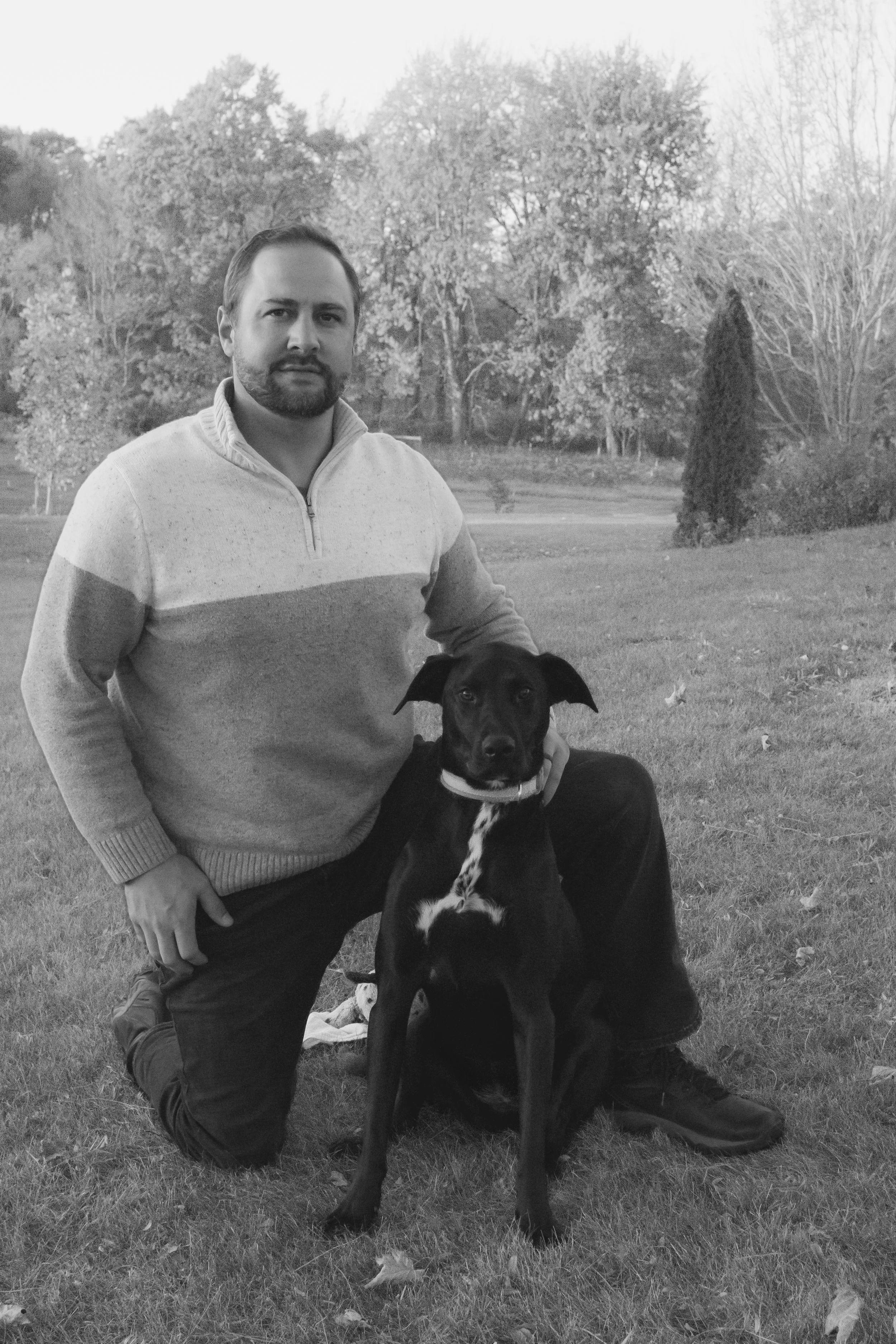 dad and dog posing for the photographer in a meaningful way at a park in dekalb indiana