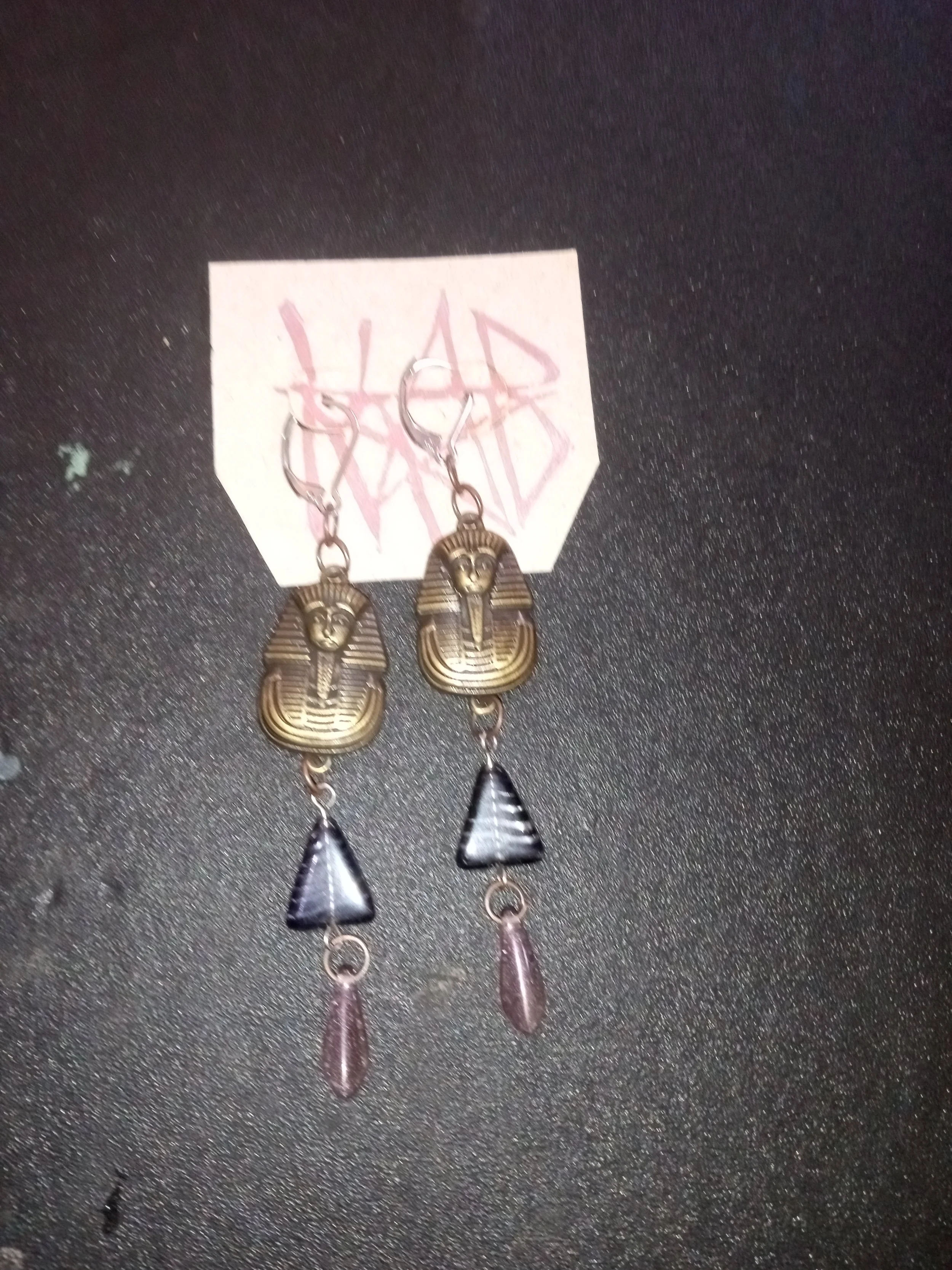 Pair of earrings featuring Egyptian hieroglyphic designs, including a scarab and a winged scarab. Artisan, Handmade, Grass valley, nevada county, Kale Burnett Earrings, art.