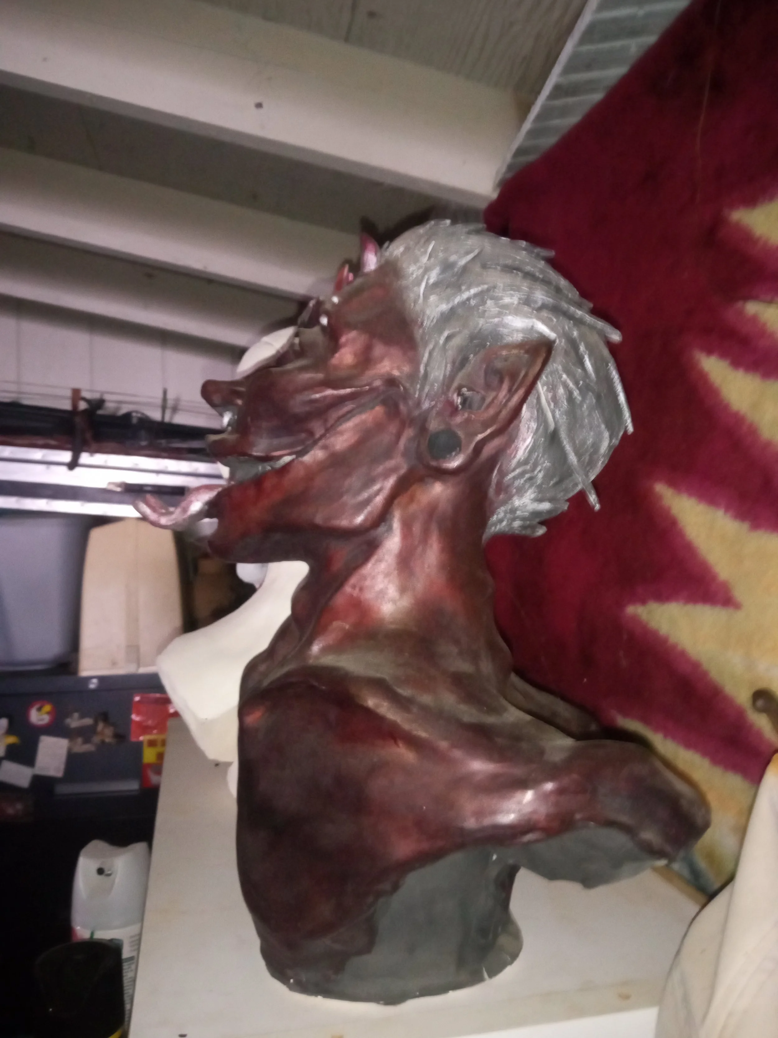 A ceramic sculpture of a person with long hair and a beard, wearing glasses and a headband, resting their face on their hand. Artisan, Handmade, Grass valley, nevada county, Kale Burnett, Ceramic Sculpture of a demon, art, ceramics.