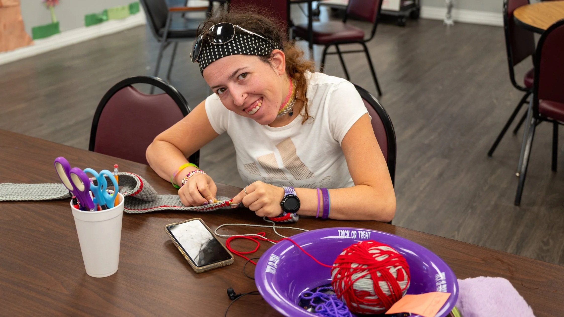 Vocational services participant making crafts at the Epilepsy Center of Northwest Ohio, developing work skills and creating items that are sold to raise funds and support program sustainability.