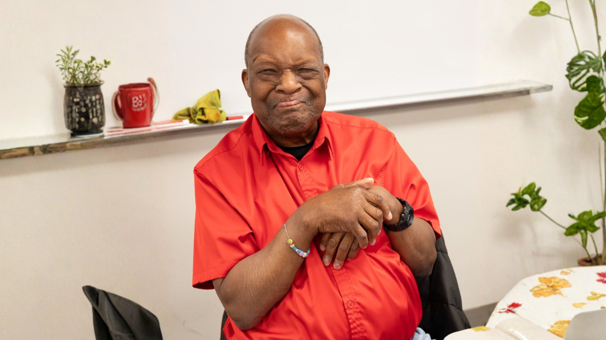 Adult participant smiling during an adult services program at the Epilepsy Center of Northwest Ohio, reflecting supportive, community-based care and connection.
