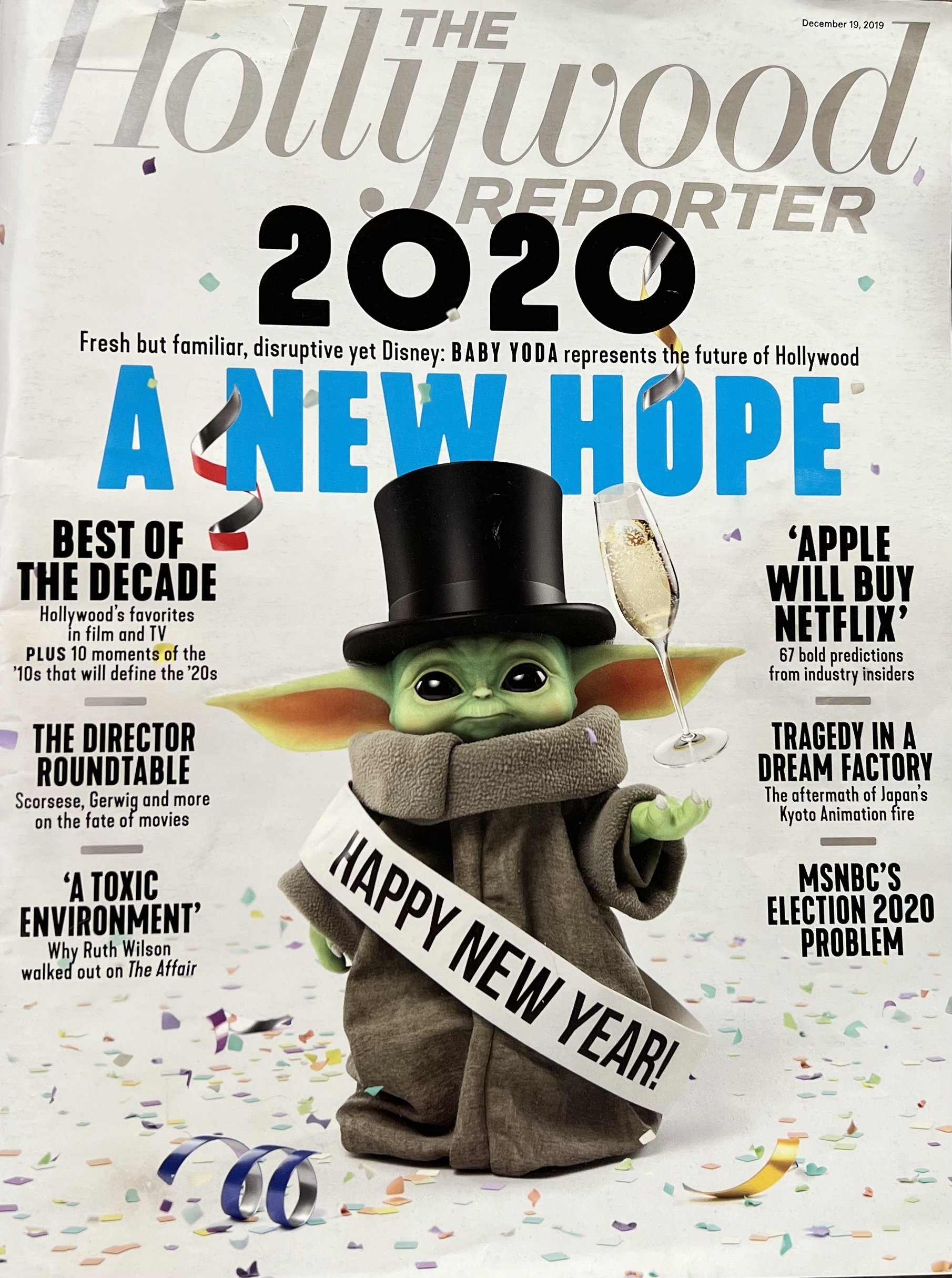Cover of the Hollywood Reporter magazine dated December 19, 2019, featuring Baby Yoda (Grogu) from Disney's The Mandalorian wearing a top hat and robe, holding a glass of champagne, with colorful confetti and streamers around. The text on the cover highlights the year 2020, New Year's wishes, and articles on Hollywood trends, predictions, and industry insights.
