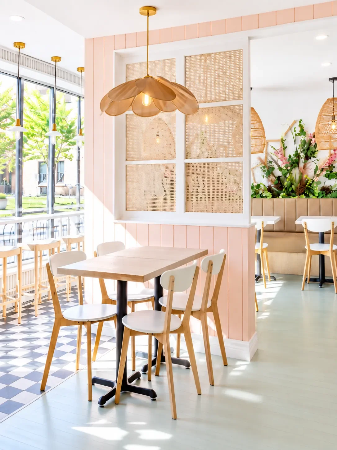 Design de café par Rübik Design : cloison en rotin, murs rose poudré et suspension pétale