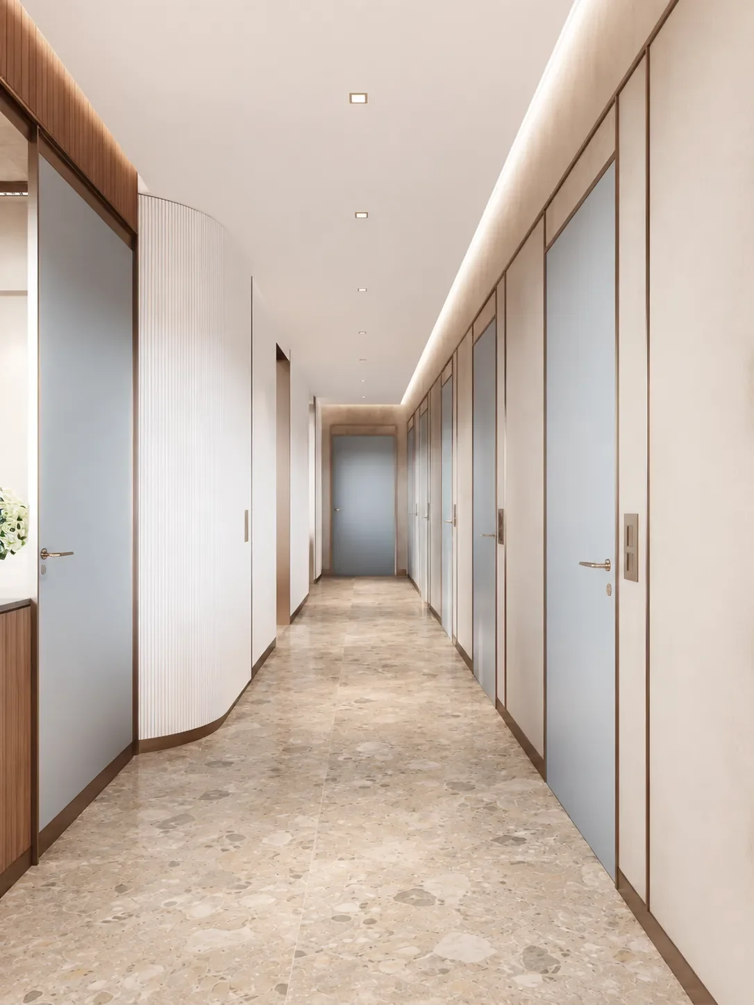 Aménagement de cabinet dentaire par Rübik Design : corridor menant aux salles de traitement, portes bleues et plancher en terrazzo