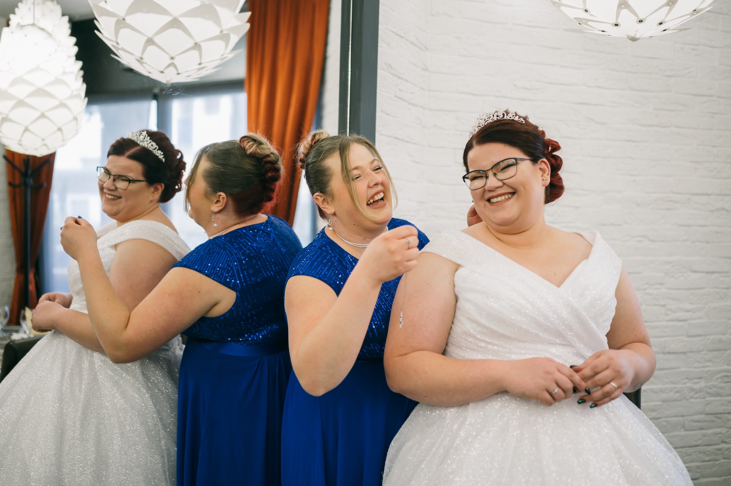Man adjusting his necktie in a black-and-white photo.