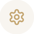 Icon of a gear or settings symbol in gold on a light background