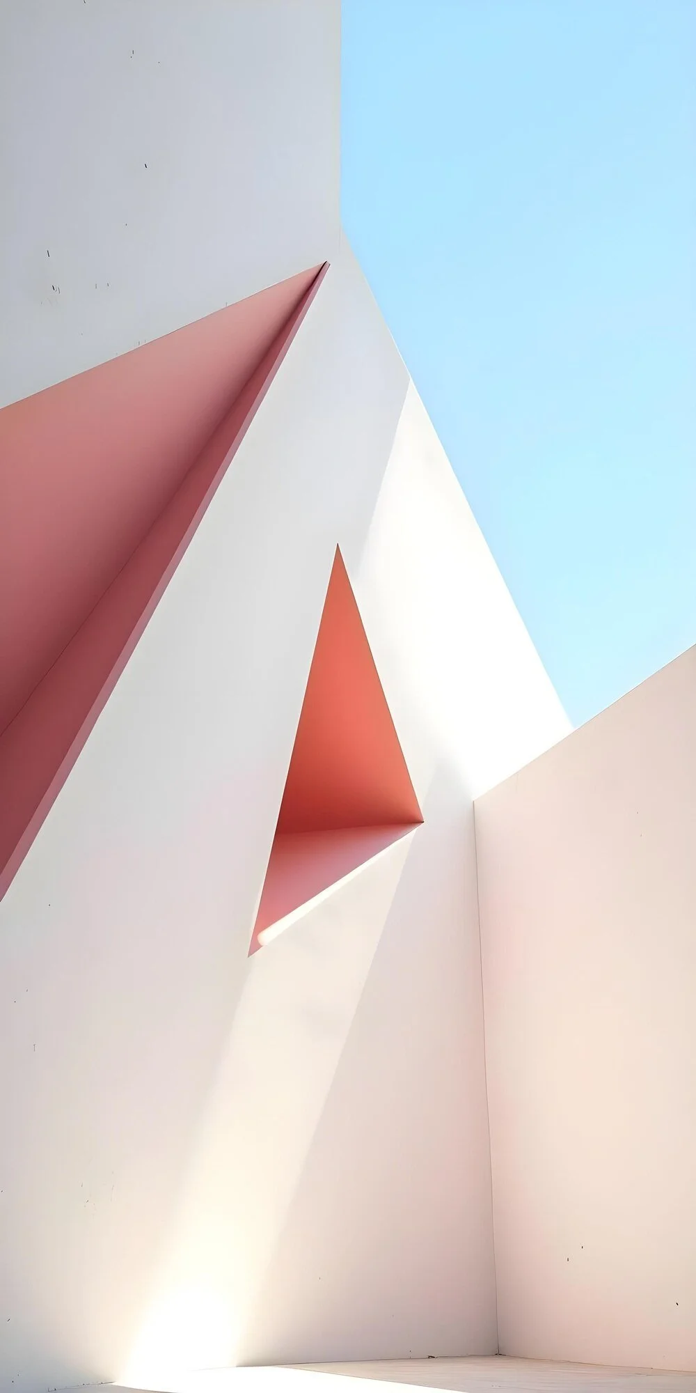 Abstract architectural shot of a white building with pink and white cut-out shapes and a blue sky above.
