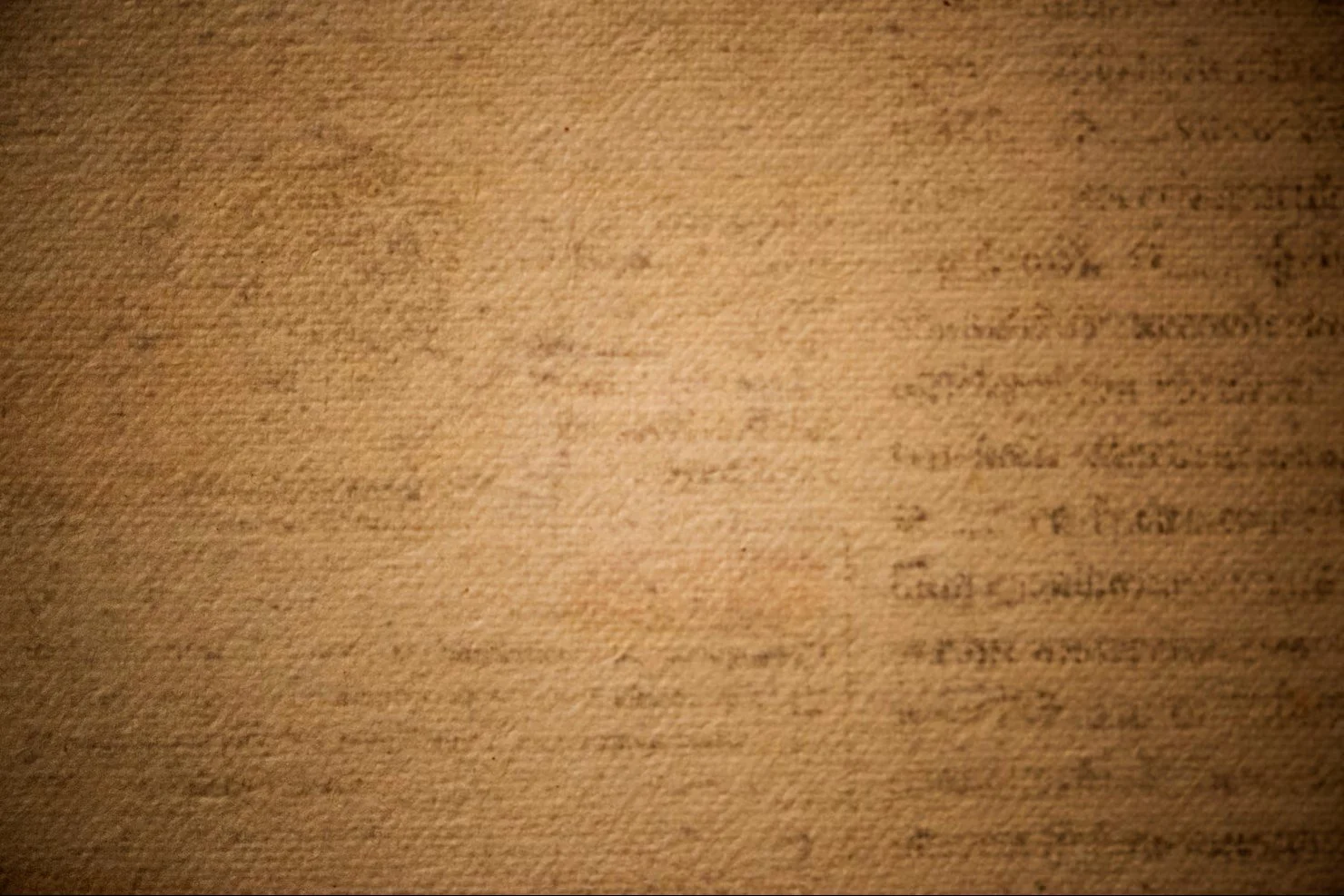 Blurred and dimly lit text on a paper or card
