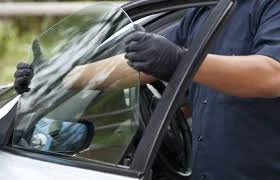 Person cleaning replacing car door glass