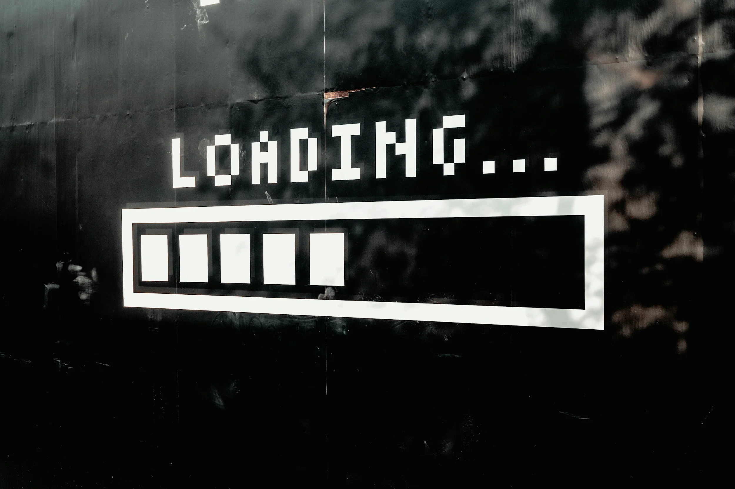 Digital display showing the word 'Loading...' with a progress bar beneath it, partially filled.