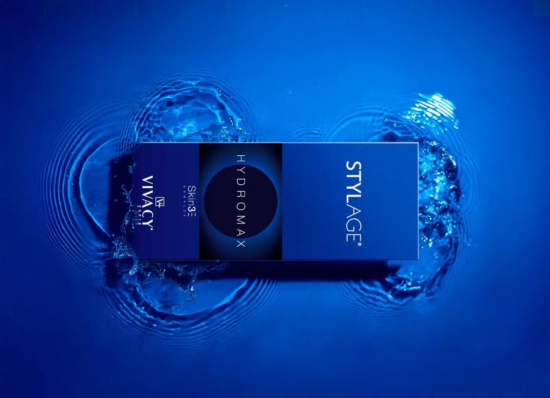 A blue box of skincare products from VIVACY with the labels STYLAGE, HYDRMAX, and SKIN3, submerged in water with ripples around it.  Skin treatment