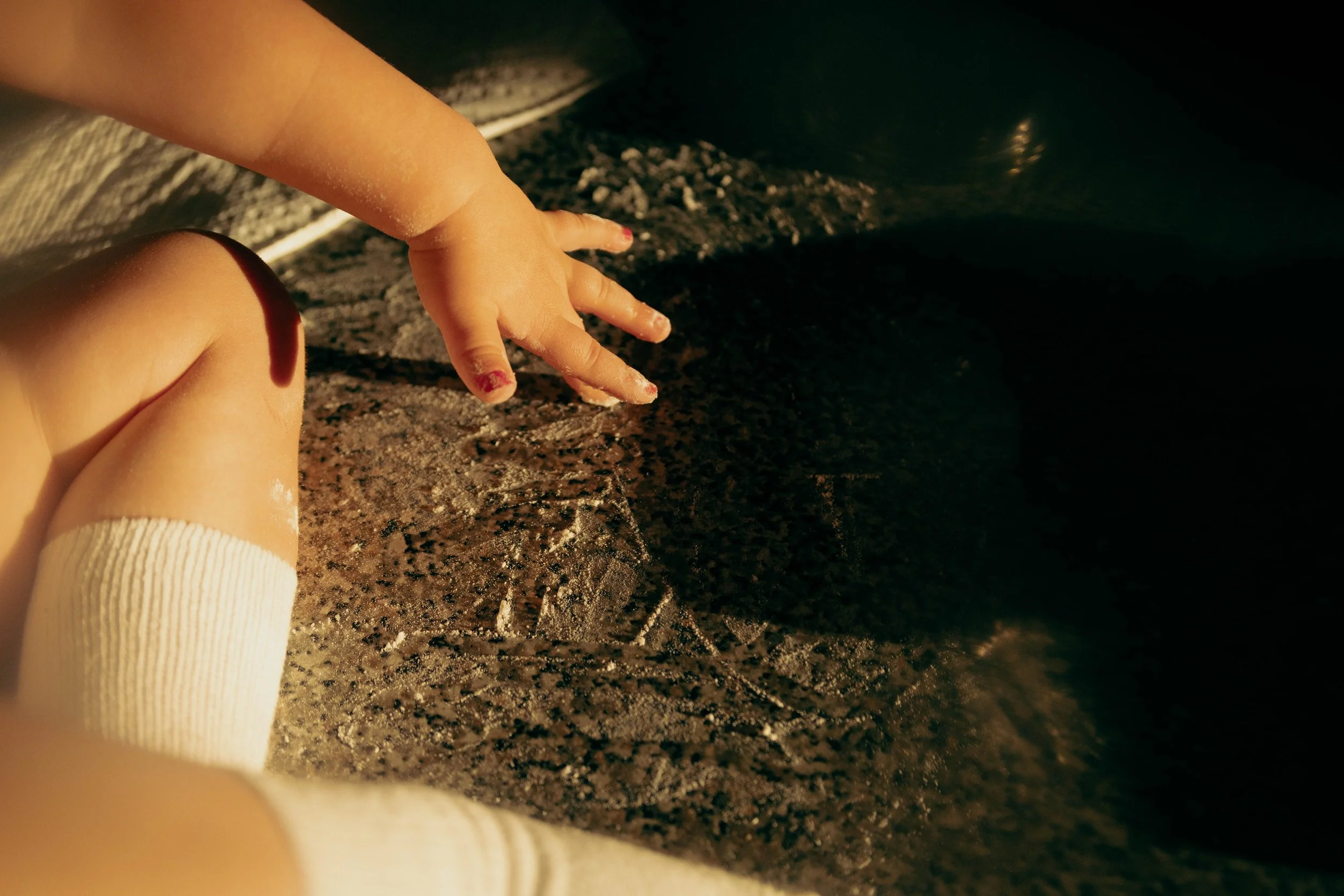 Close-up of a child's hand making sourdough