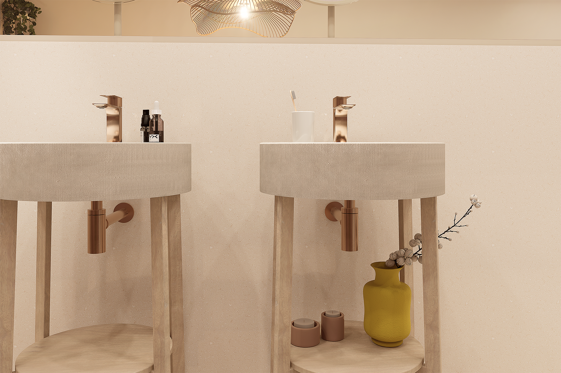 Deux lavabos en béton avec robinets en bronze, un petit objet de décoration et des produits de soins, avec un mur beige clair en arrière-plan.