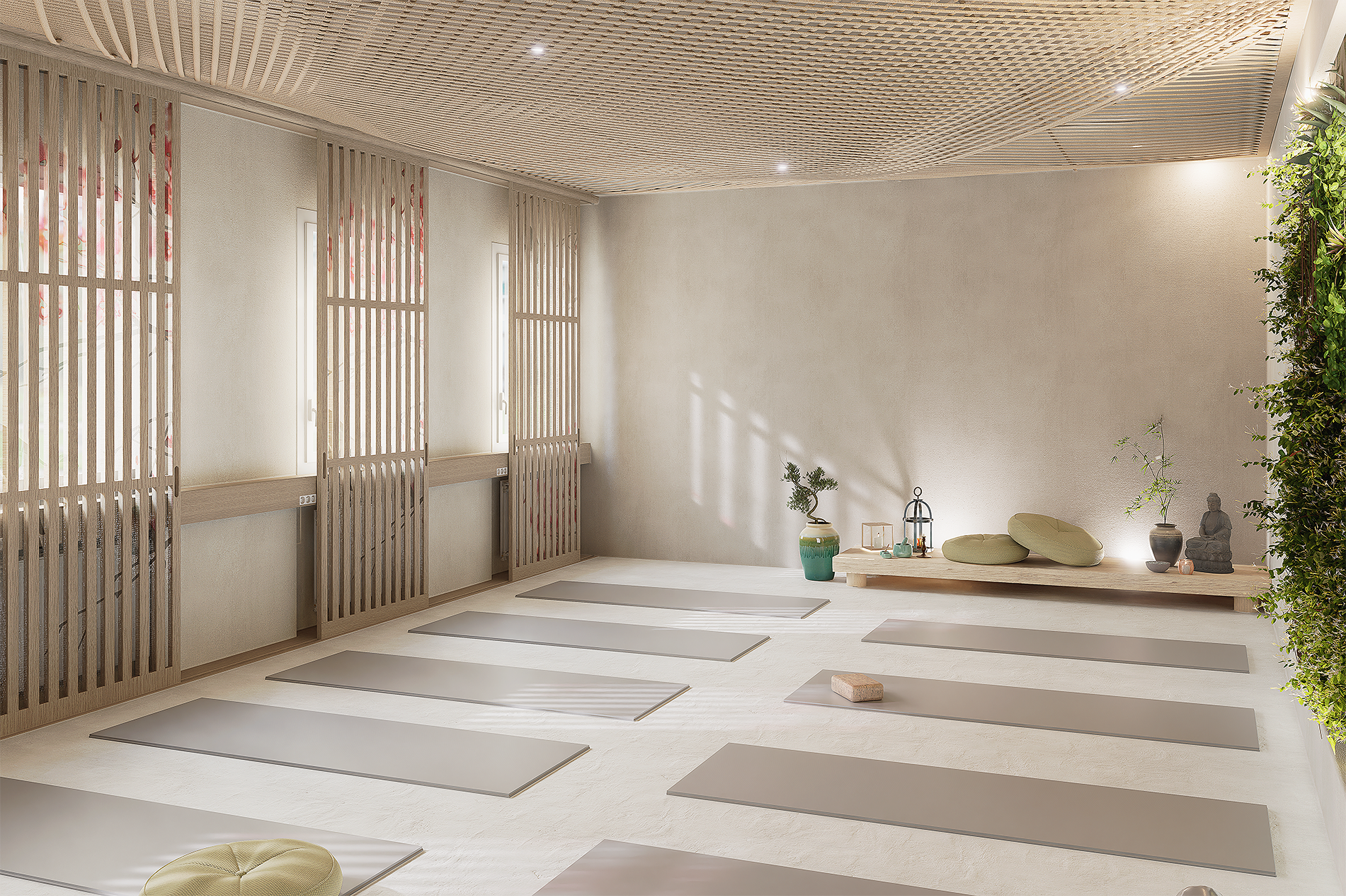 Studio de yoga lumineux avec des tapis de yoga alignés, des coussins verts, des plantes, une statuette de Bouddha, une lampe en cage, et une décoration zen.