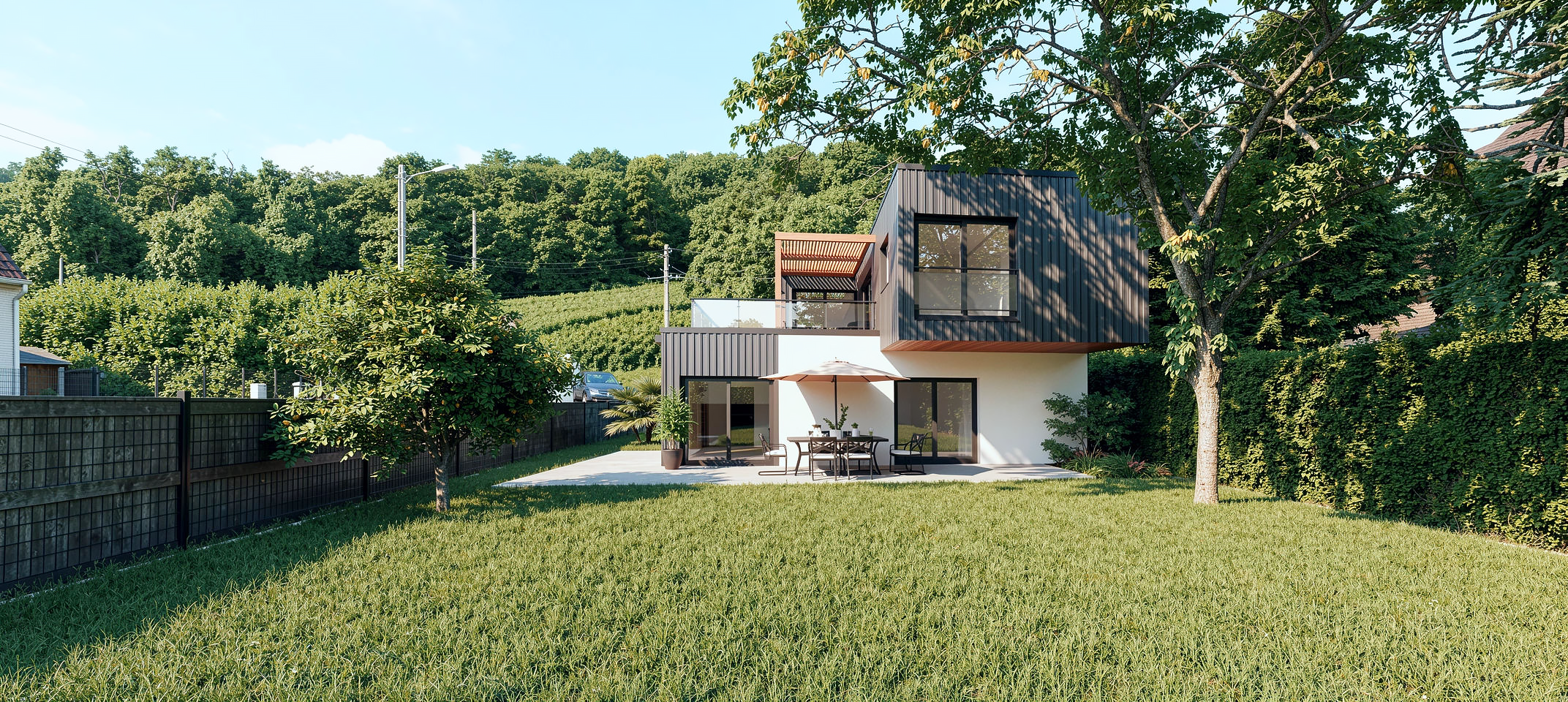 Maison moderne à deux étages avec terrasse et mobilier extérieur, entourée d'arbres et de verdure sous un ciel clair. TROYES / AUBE / Architecte d'intérieur
