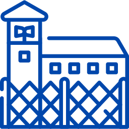 Outline of a prison or detention center with a guard tower and a fence.