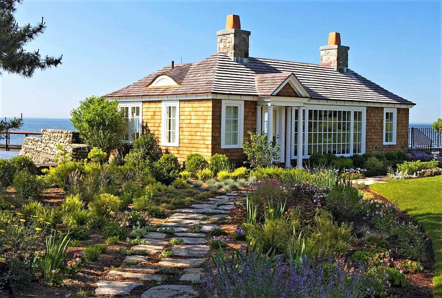 Wood roofing project in Southport, Connecticut featuring the property pool house with Western red cedar 1" tapersawns with copper flashing, gutters, and finial.