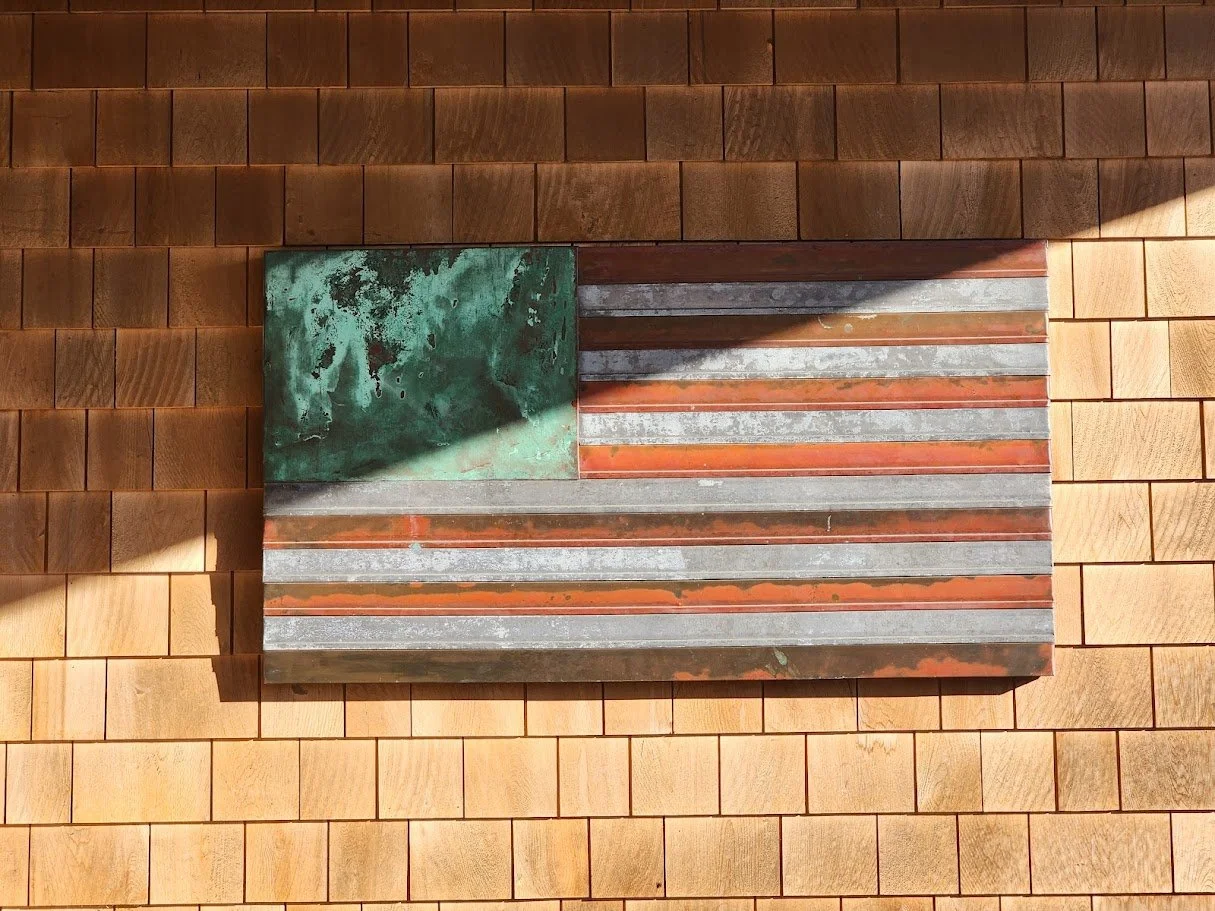 wood roofing and siding with custom copper American flag by The Wood Roofing Co., in Portsmouth, RI, a division of Slate & Copper Services.