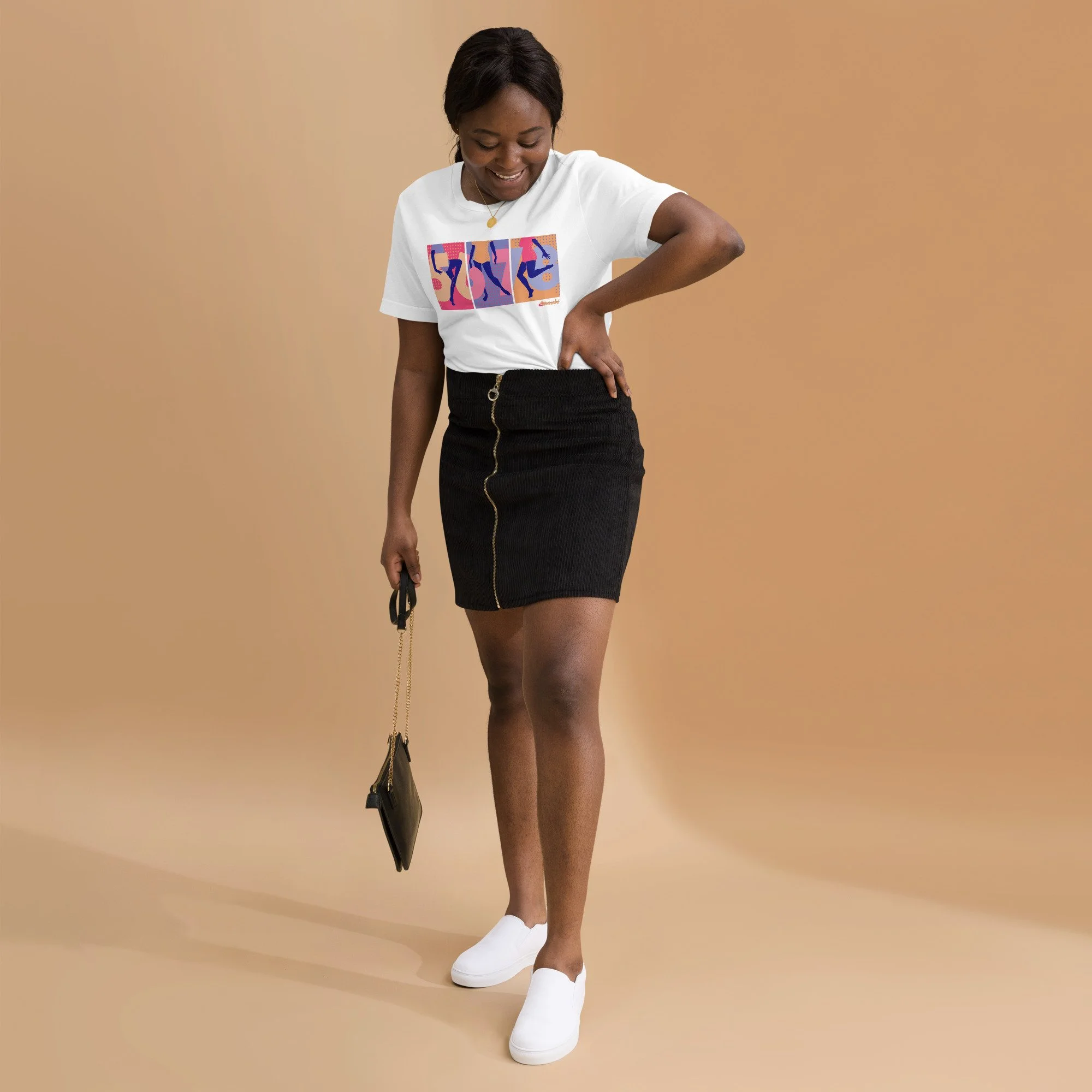 A black woman in her 20s wearing a white graphic tee with 5,6,7,8 and a dancer in three panels, a demin skirt, and white shoes.