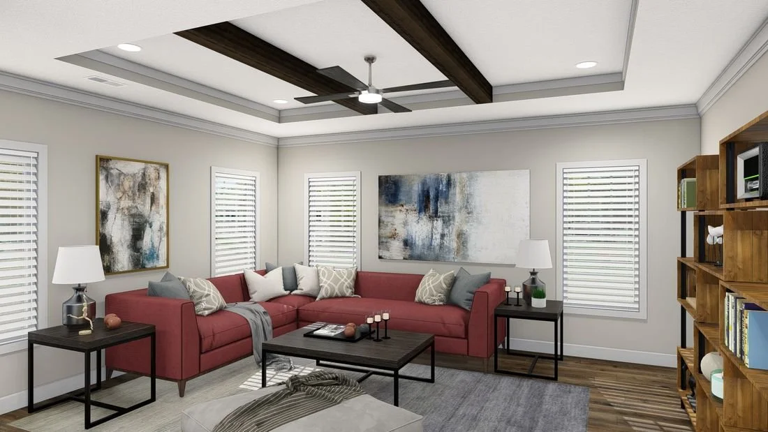 Living room with a red sectional sofa, abstract wall art, wooden bookshelf, and windows with white blinds.