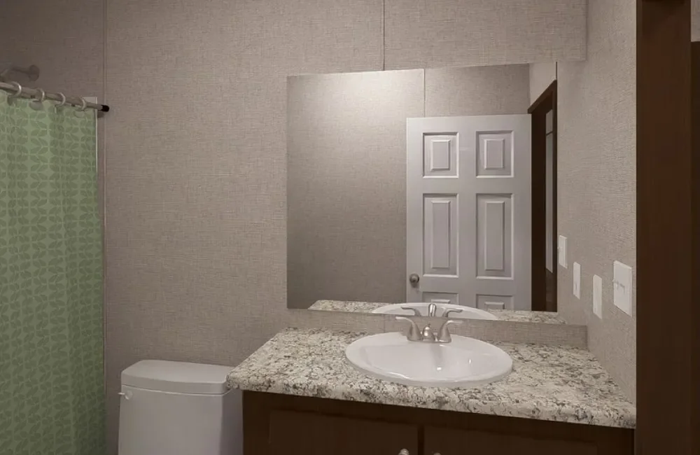 Bathroom with granite countertop vanity, white sink, large mirror, toilet, and green shower curtain.