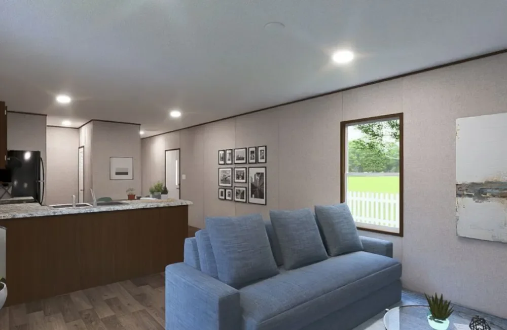 Living room with blue sofa, window with greenery outside, and photo gallery on wall.