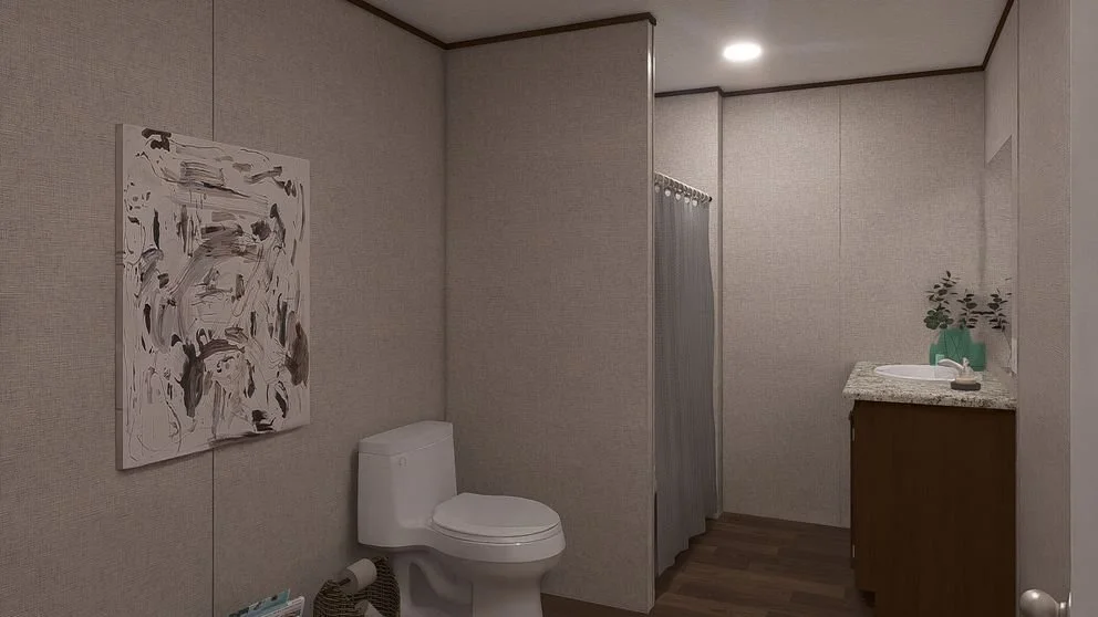 A bathroom with beige walls, a toilet, a vanity with a sink, a mirror, and a gray shower curtain.