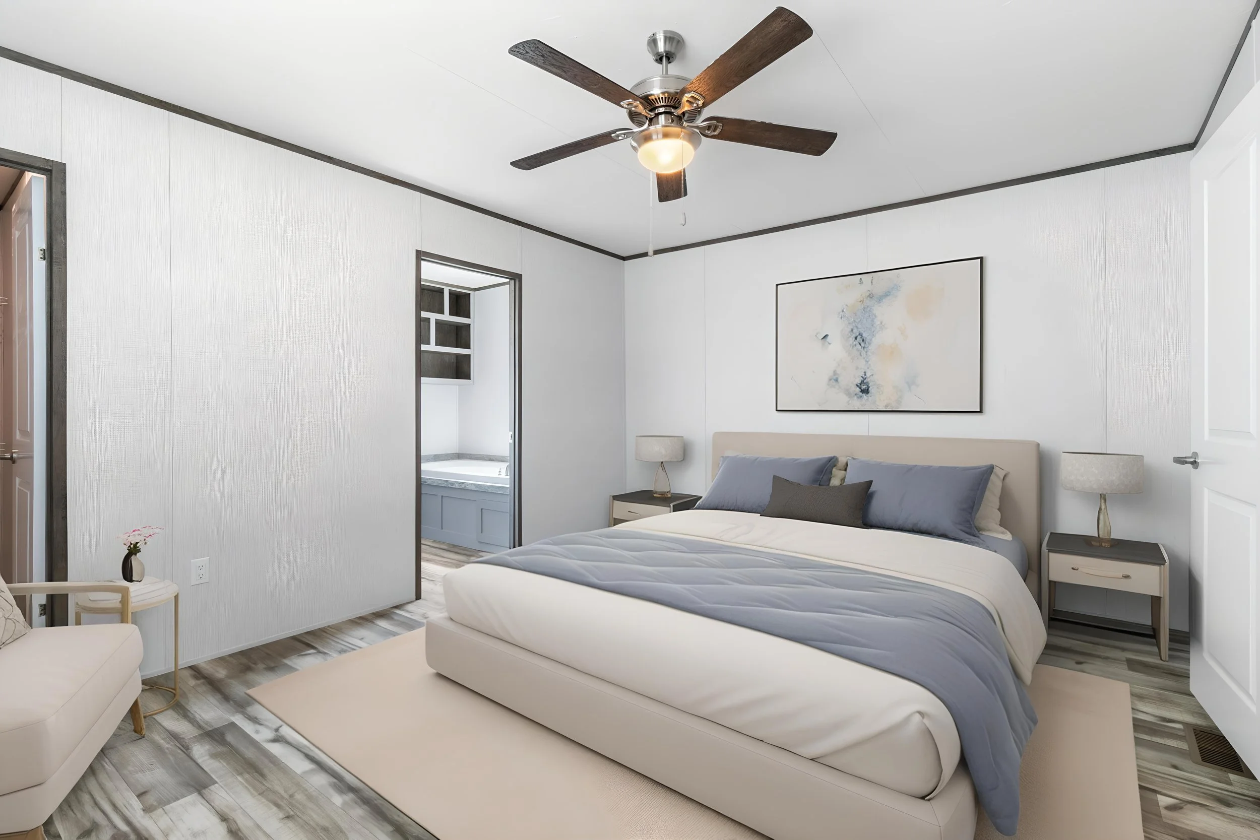 A modern bedroom with a ceiling fan, framed abstract art, beige bed with gray and beige bedding, nightstands with lamps, and a small table with a flower vase.