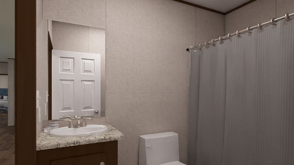 Bathroom with a sink, a mirror, a toilet, and a shower curtain in a beige-walled room.