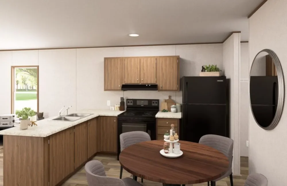 Kitchen with wooden cabinets, black appliances, a round dining table with four gray chairs, and a window with a view of greenery.