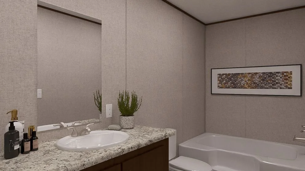 Bathroom with a granite countertop, potted plants, a large mirror, a framed artwork, and a bathtub.