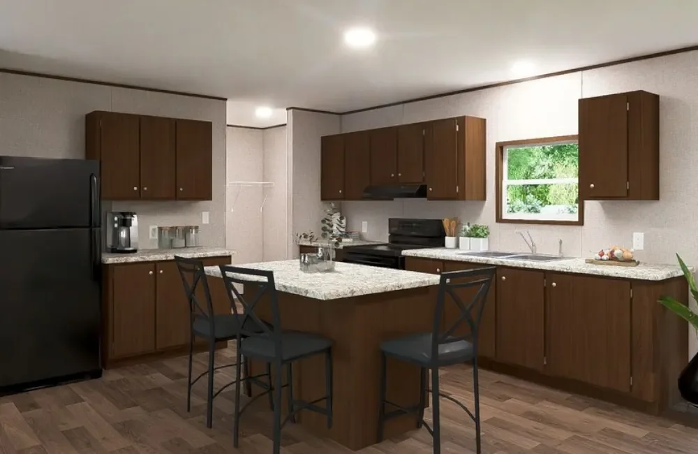 Kitchen with wooden cabinets, black refrigerator, granite countertops, small island, black chairs, window with greenery outside, white walls, and wooden flooring.