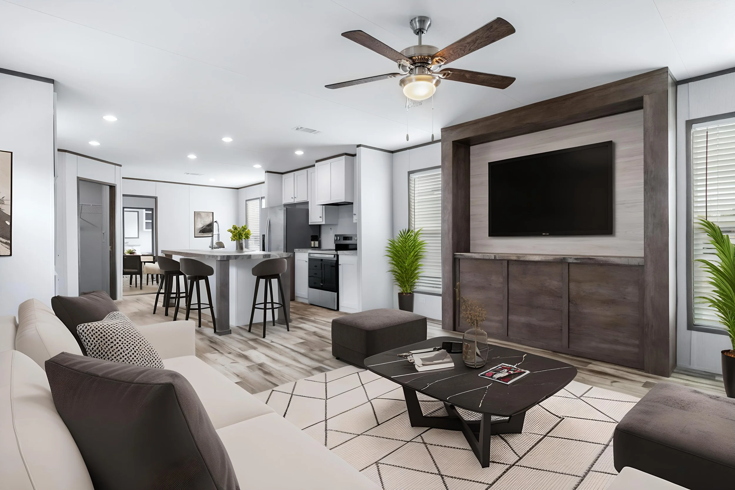 Open-concept living room and kitchen with white walls, wood flooring, modern furniture, a ceiling fan, and large windows with blinds.