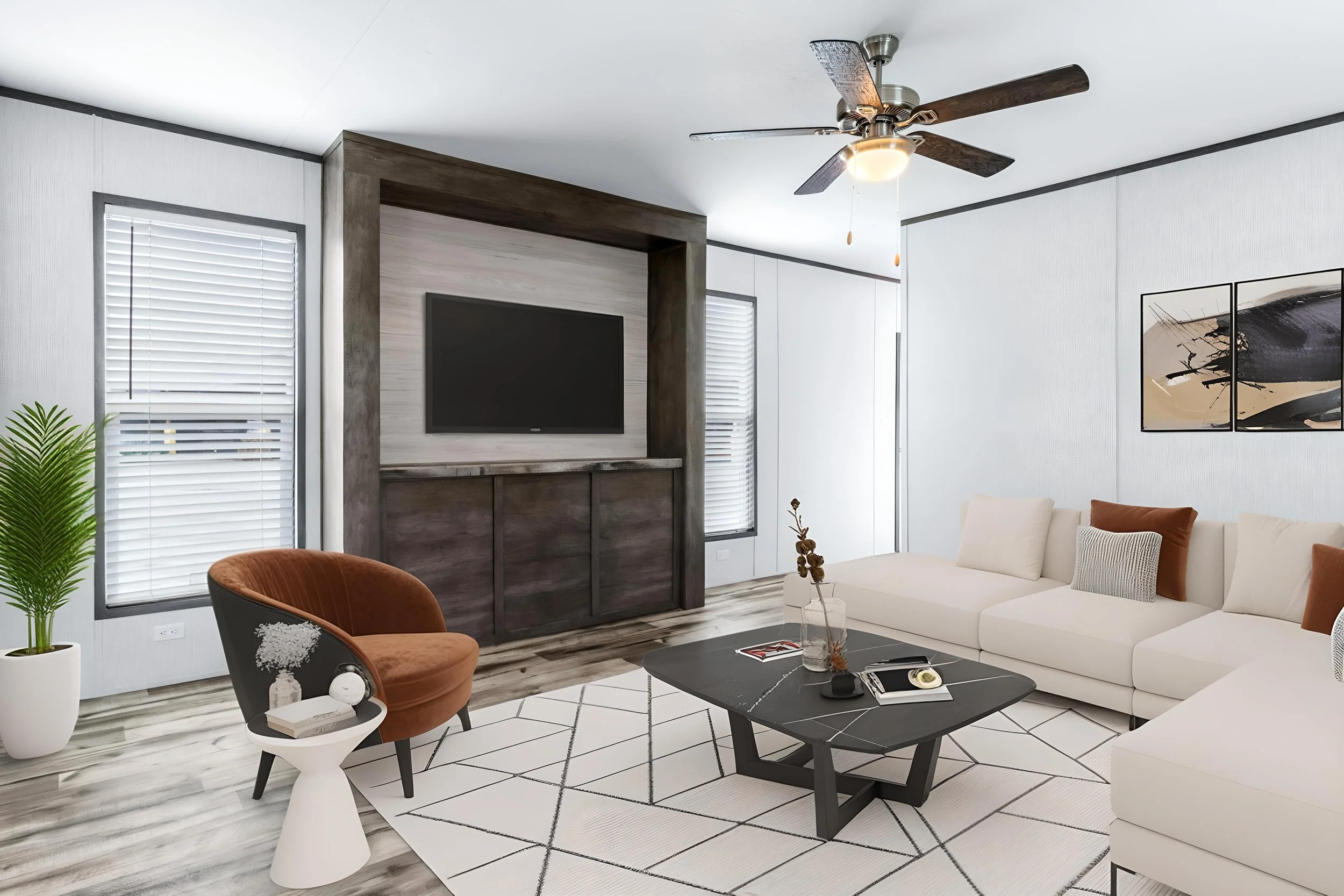 Modern living room with white walls, white sofa, orange chairs, black coffee table, a wall-mounted TV, large windows with blinds, and artwork on the wall, with ceiling fan overhead.
