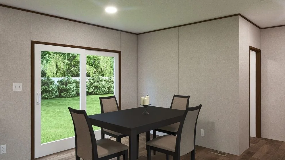 Dining room with a black table, four beige chairs, a candle centerpiece, beige walls, a sliding glass door leading to a green yard, and a doorway on the right.