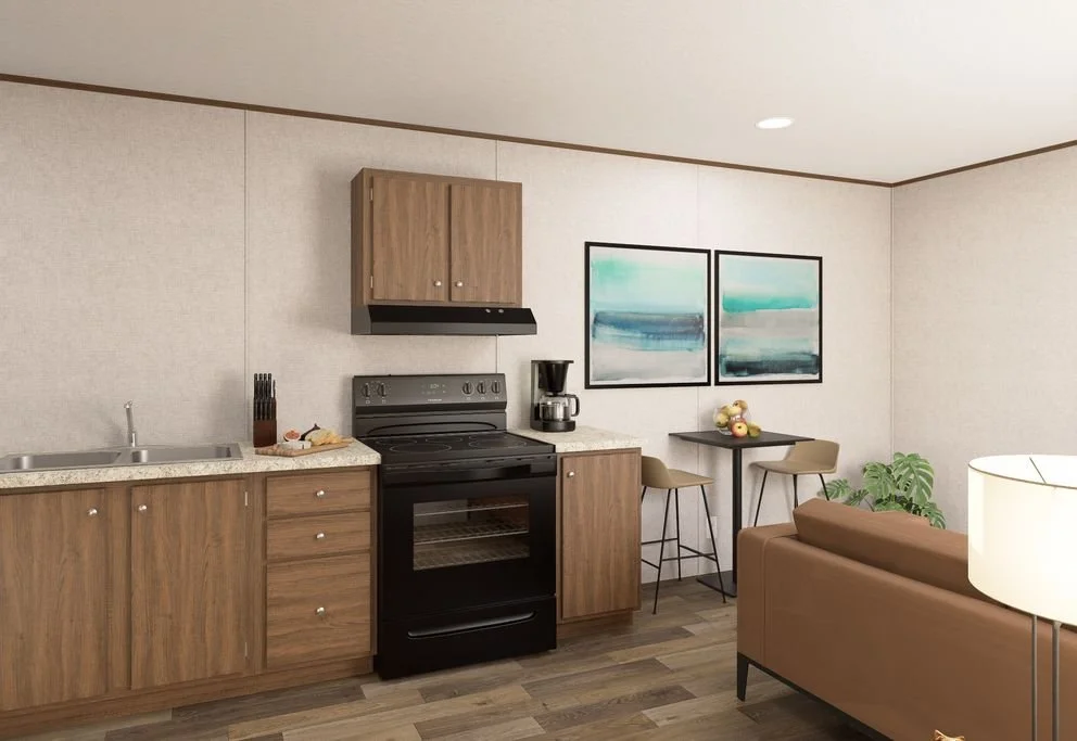 Kitchen area with wooden cabinets, a black stove, a coffee maker, a small table with two chairs, a couch, and wall art with abstract blue and green paintings.